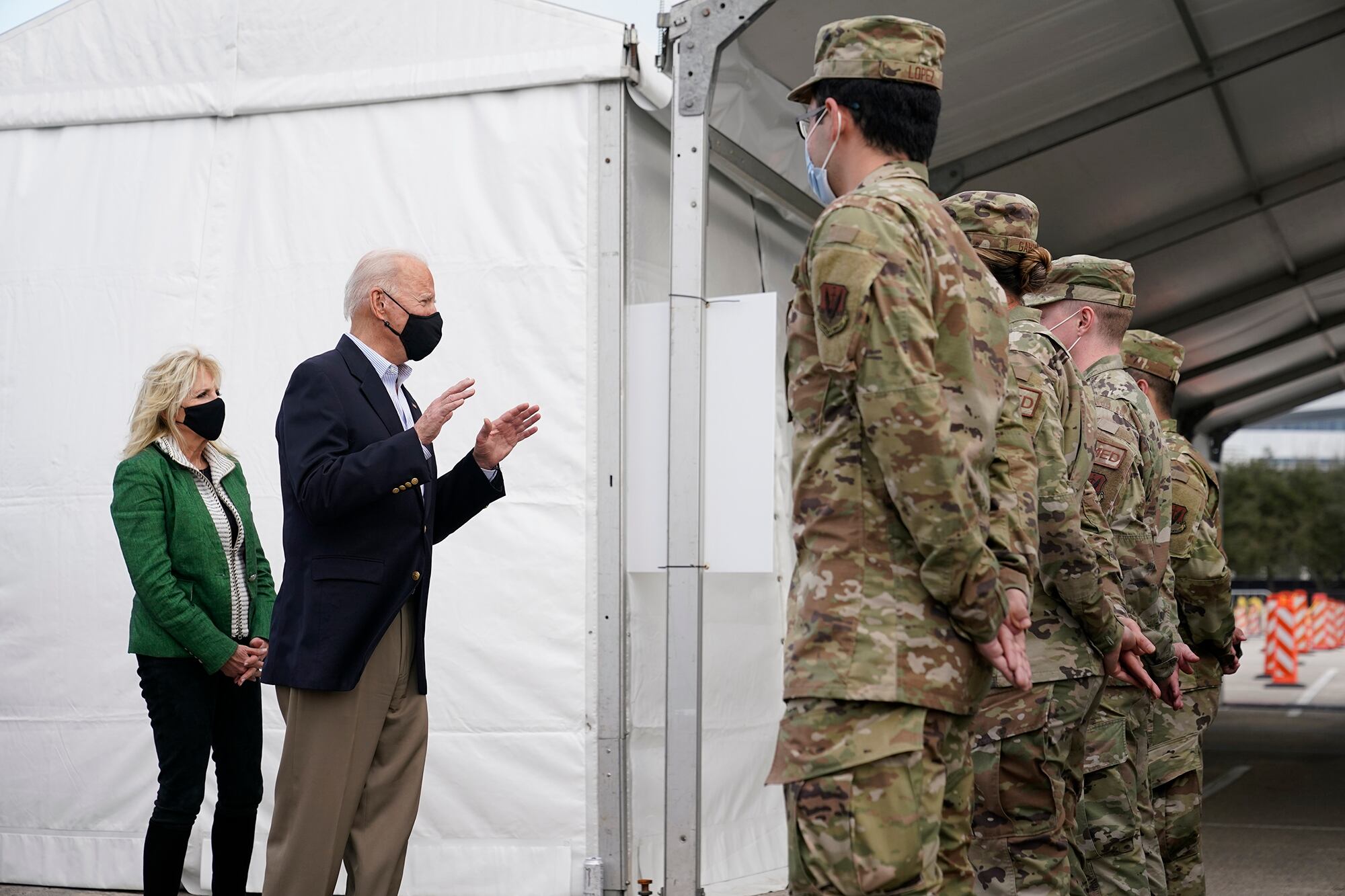 President Joe Biden and first lady Jill Biden meet with troops at a FEMA COVID-19 mass vaccination site at NRG Stadium, Friday, Feb. 26, 2021, in Houston.