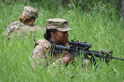 Staff Sgt. Michelle Spell takes a defensive position during a training exercise at the Camp Gilbert C. Grafton Training Center, near Devils Lake, N.D., July 16, 2019.