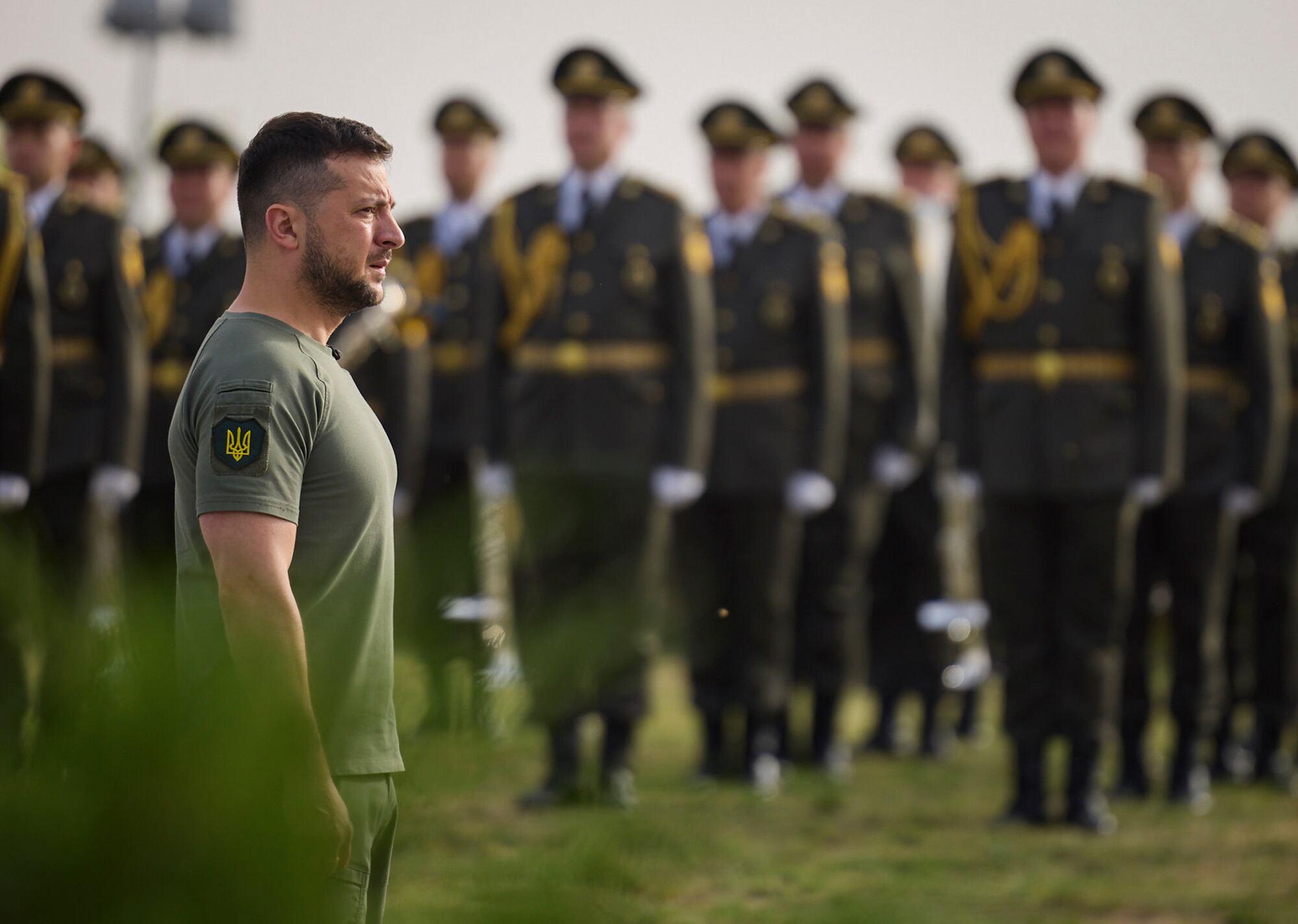 Ukrainian President Volodymyr Zelenskyy stands in front of lined up soldiers as he arrives for State Flag Day celebrations in Kyiv, Ukraine, Tuesday, Aug. 23, 2022.