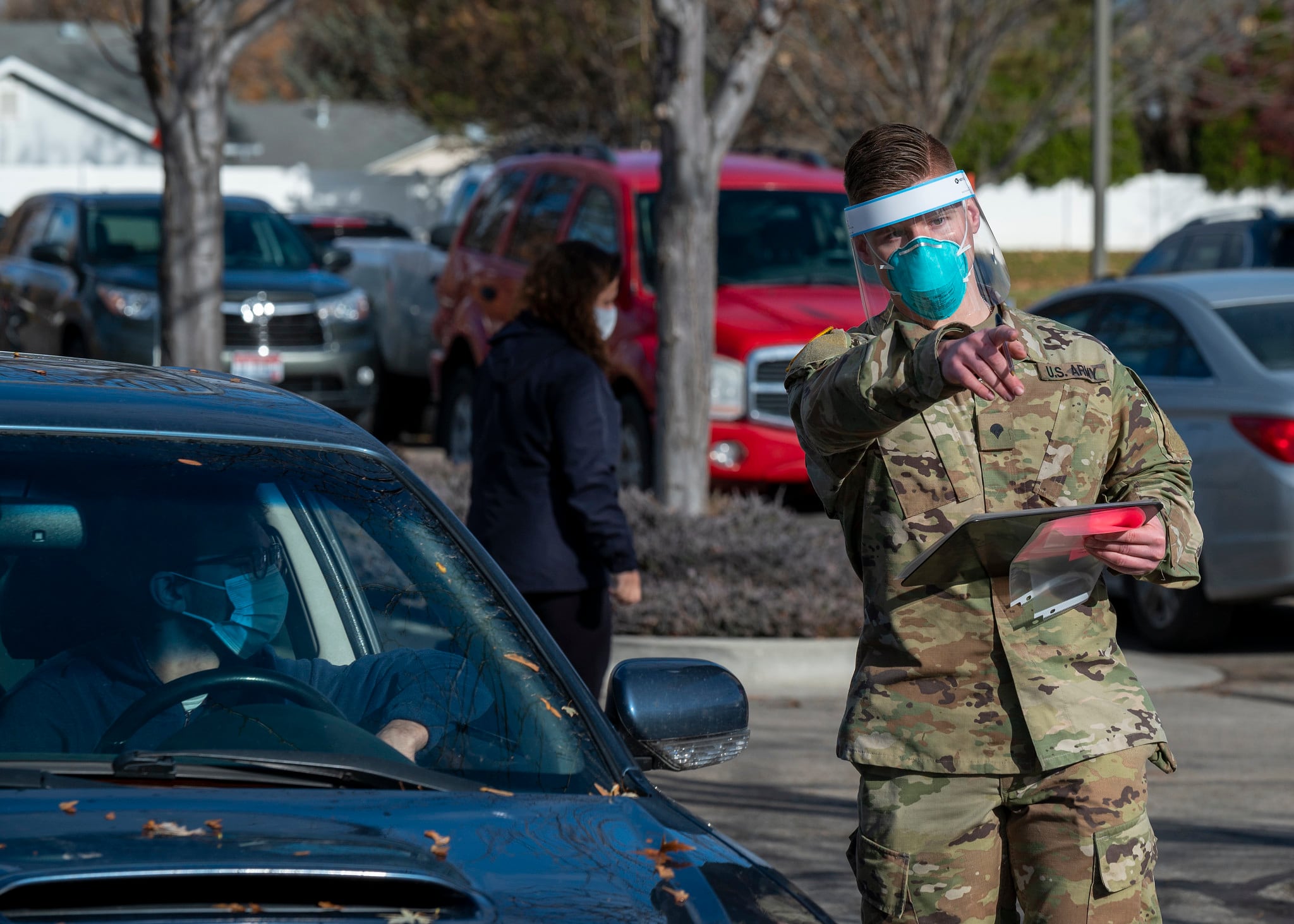 An Idaho Army National Guardsman directs a driver during a COVID-19 screening at Saint Alphonsus Medical Group Meridian Health Plaza Urgent Care, Meridian, Idaho, Nov. 19, 2020.