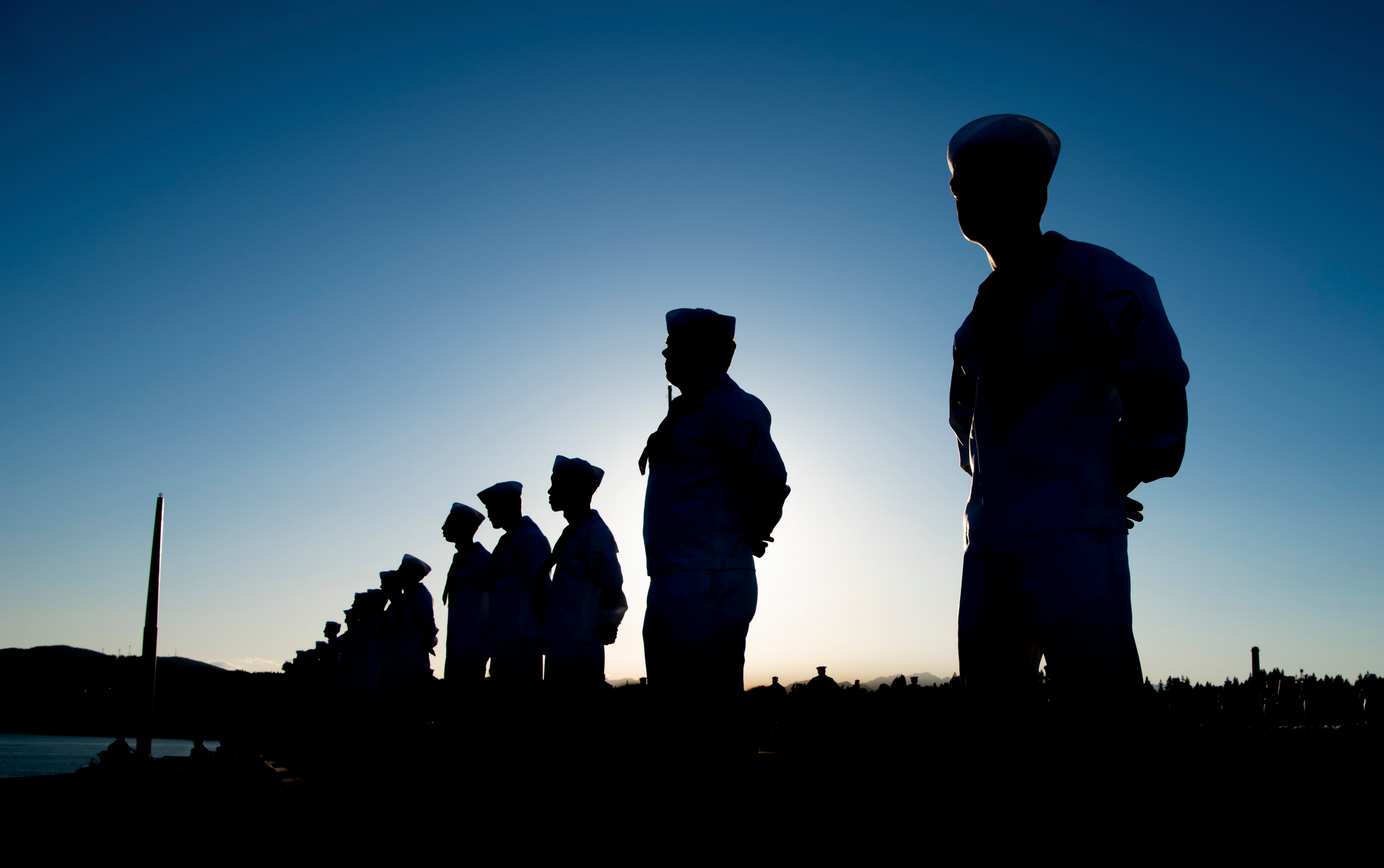 Sailors man the rails on the flight deck of the aircraft carrier Nimitz on its return to home port in Bremerton, Wash., July 3, 2023.