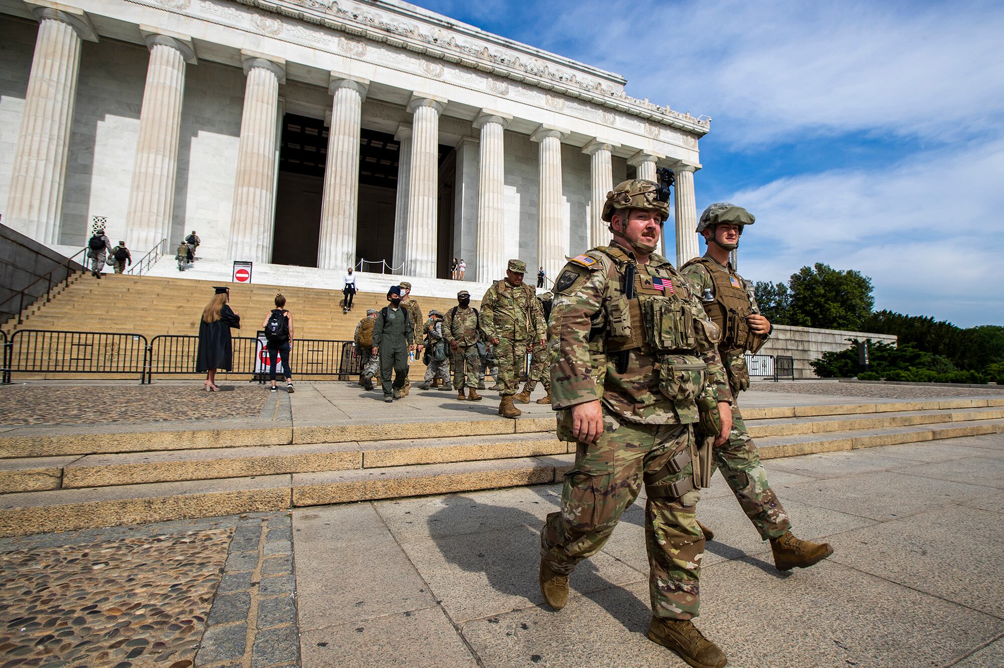 Members of the District of Columbia Army National Guard walk to their designated positions at the National Mall near the Lincoln Memorial in Washington, Wednesday, June 3, 2020, securing the area as protests continue following the death of George Floyd, a who died after being restrained by Minneapolis police officers.