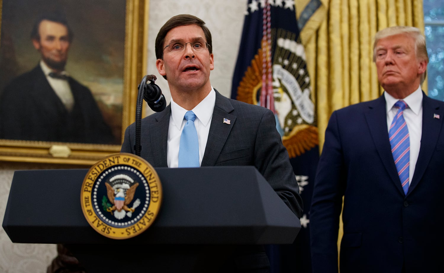 President Donald Trump looks to Secretary of Defense Mark Esper during a ceremony in the Oval Office at the White House in Washington, Tuesday, July 23, 2019.