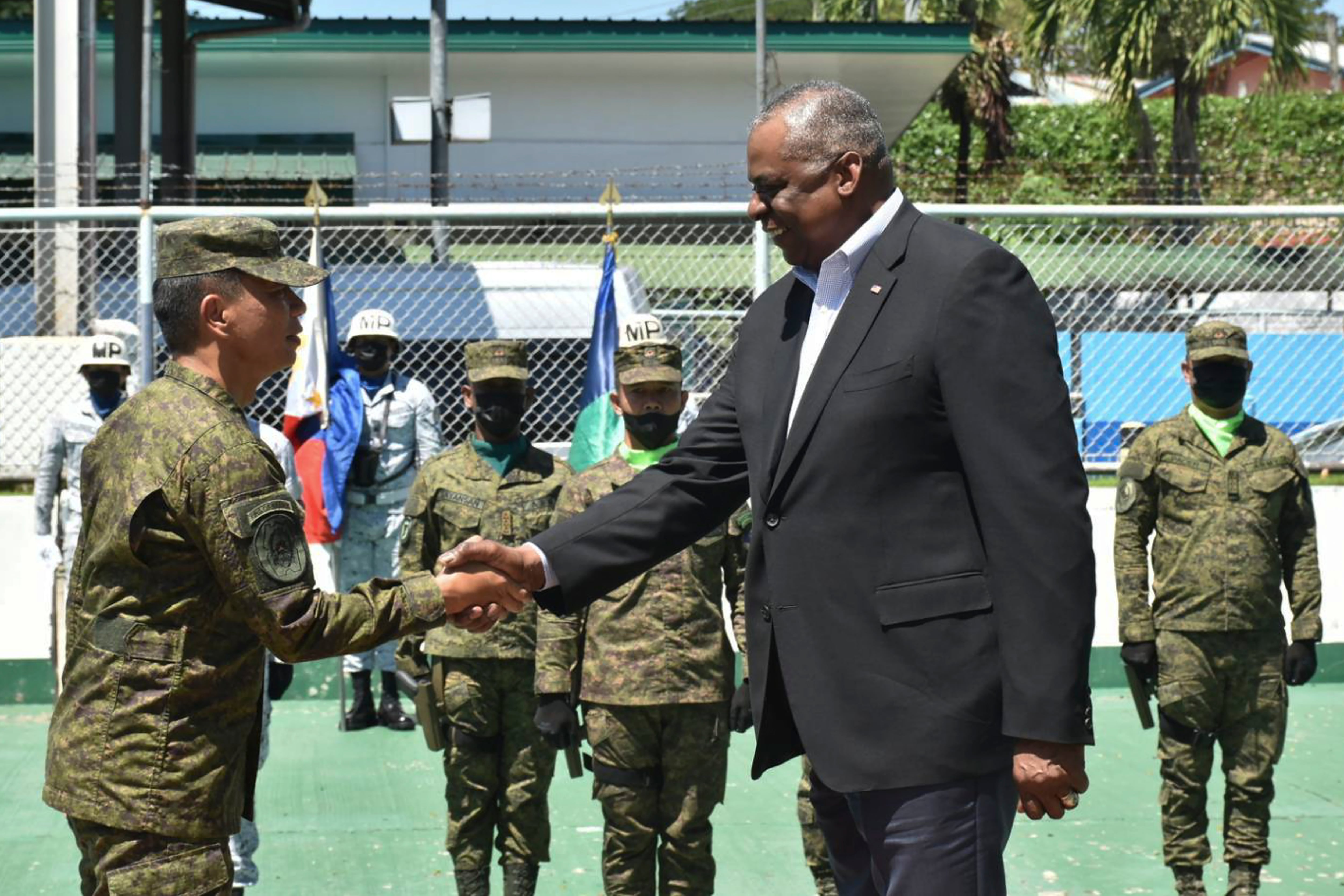 In this handout photo provided by the Command Public Information Office, Western Mindanao Command, U.S. Defense Secretary Lloyd Austin III, right, greets Western Mindanao Commander Lt. Gen. Roy Galido as he visits Camp Don Basilio Navarro in Zamboanga province, southern Philippines on Wednesday Feb. 1, 2023.