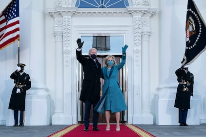 President Joe Biden and first lady Jill Biden wave as they arrive at the North Portico of the White House, Wednesday, Jan. 20, 2021, in Washington.