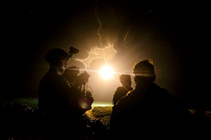 U.S. Marines watch illuminating rounds during a simulated close-air support and assault support training event at W-174, Okinawa, Japan, Aug. 18, 2020.