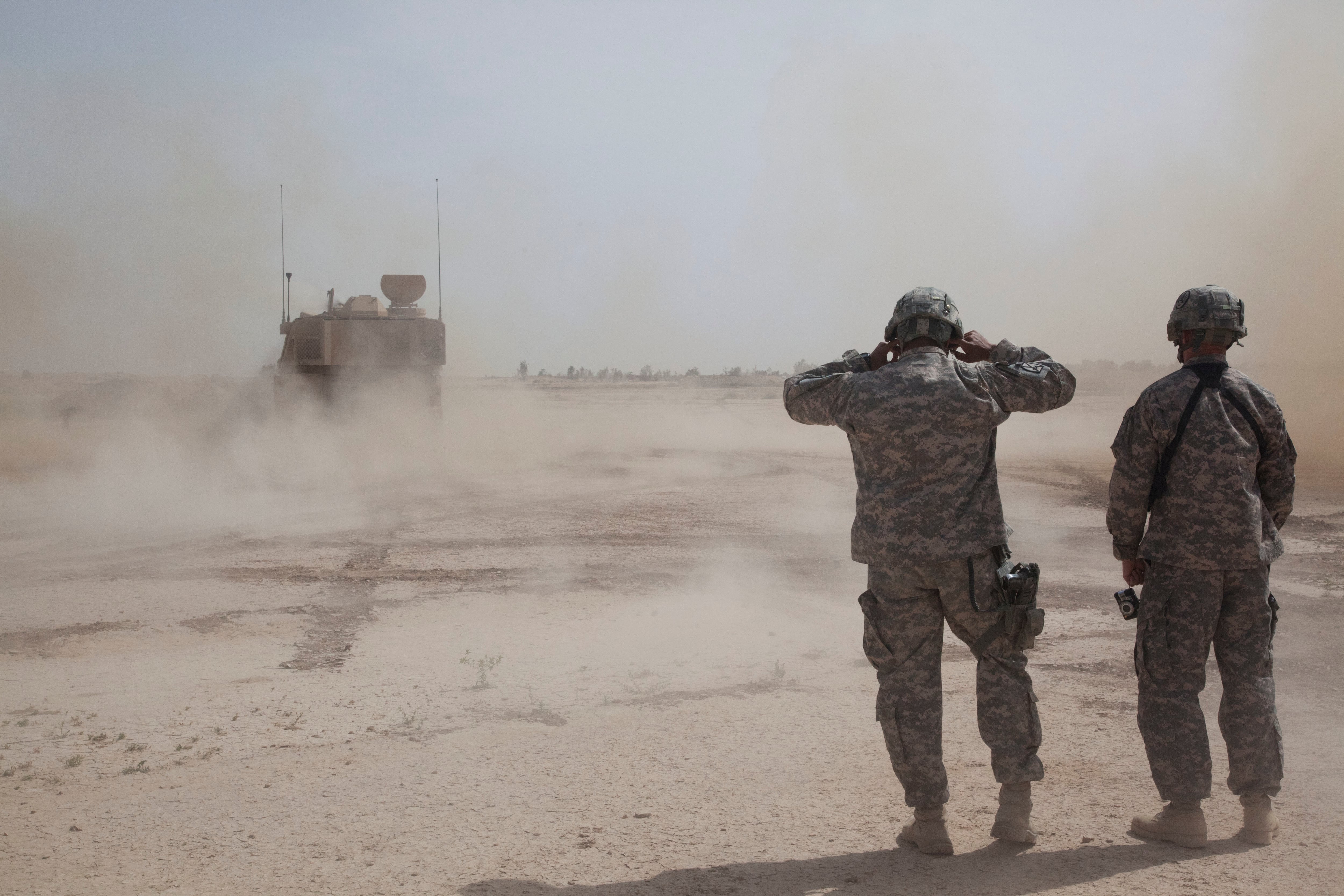 U.S. Army soldiers cover their ears during an artillery qualification at Besamaya Range in FOB Hammer, Iraq, May 6, 2011.