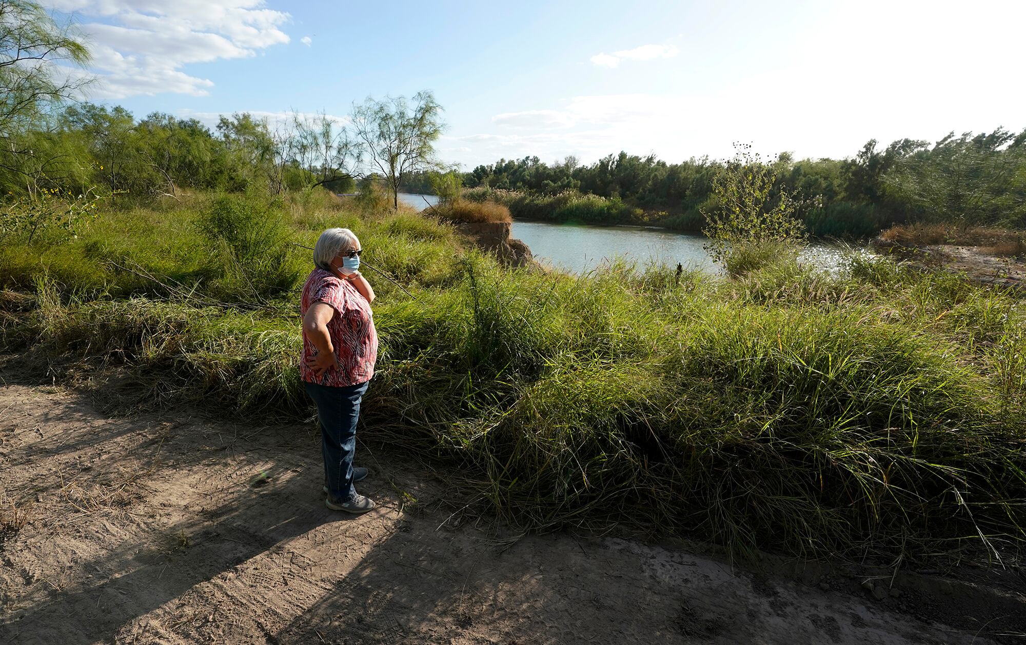 Pamela Rivas stands on her property that runs along the Rio Grande in Los Ebanos, Texas, Friday, Nov. 20, 2020.