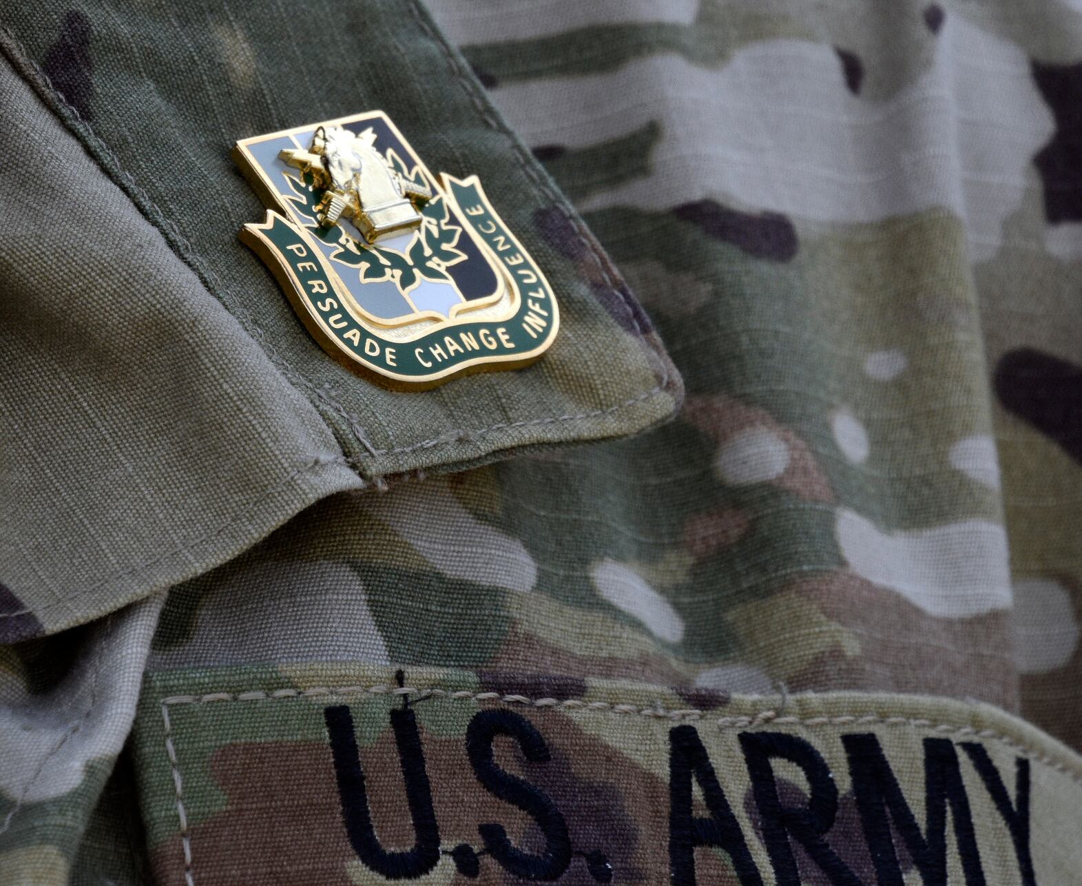 Graduates of the 80th Training Command PSYOP class receive regimental crest pins at the end of their field exercise at Fort Hunter Liggett, California, Feb. 6, 2019.