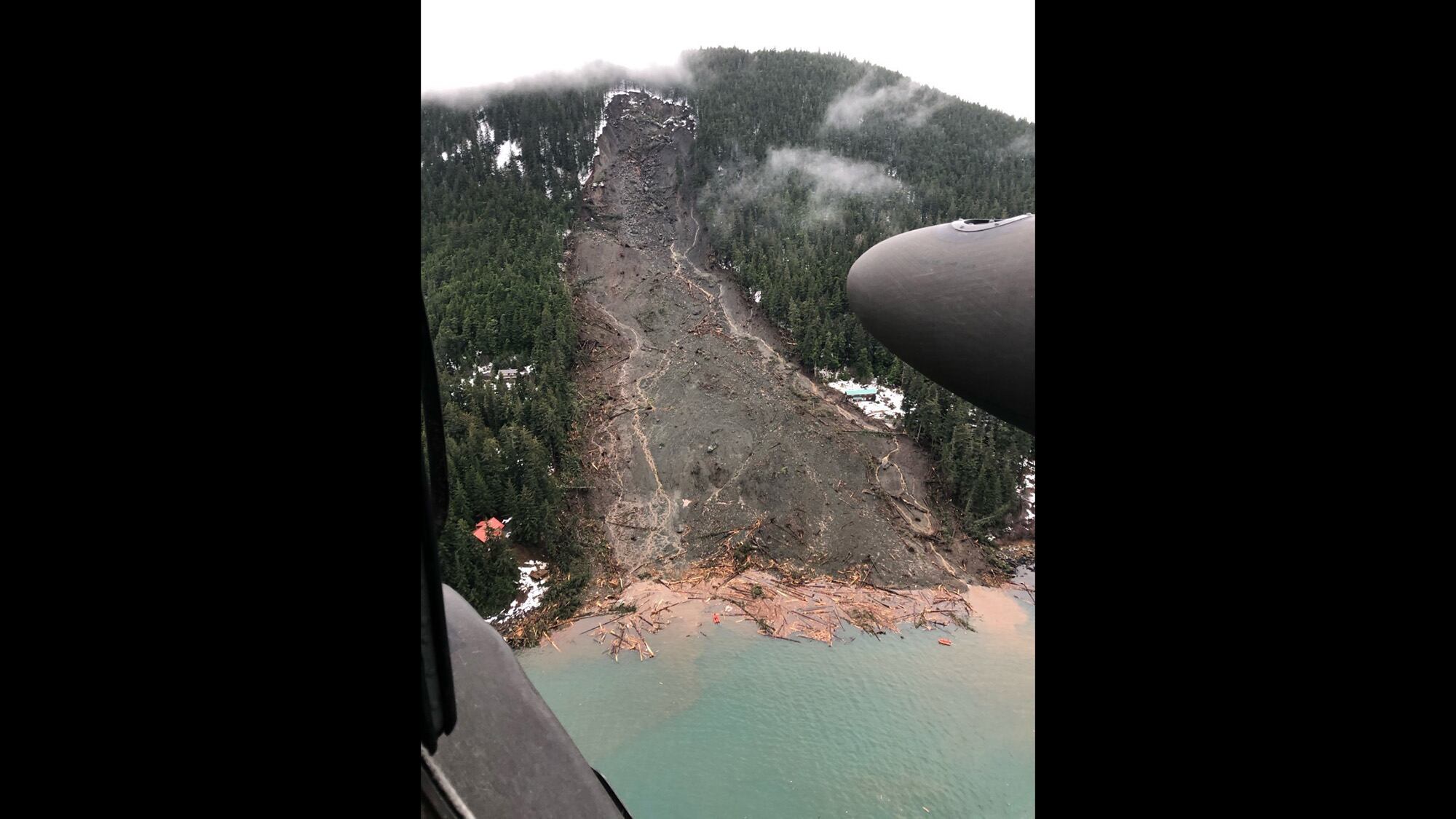 An Alaska Army National Guard UH-60 Black Hawk helicopter conducts search and rescue in Haines after a major landslide Dec. 3, 2020.