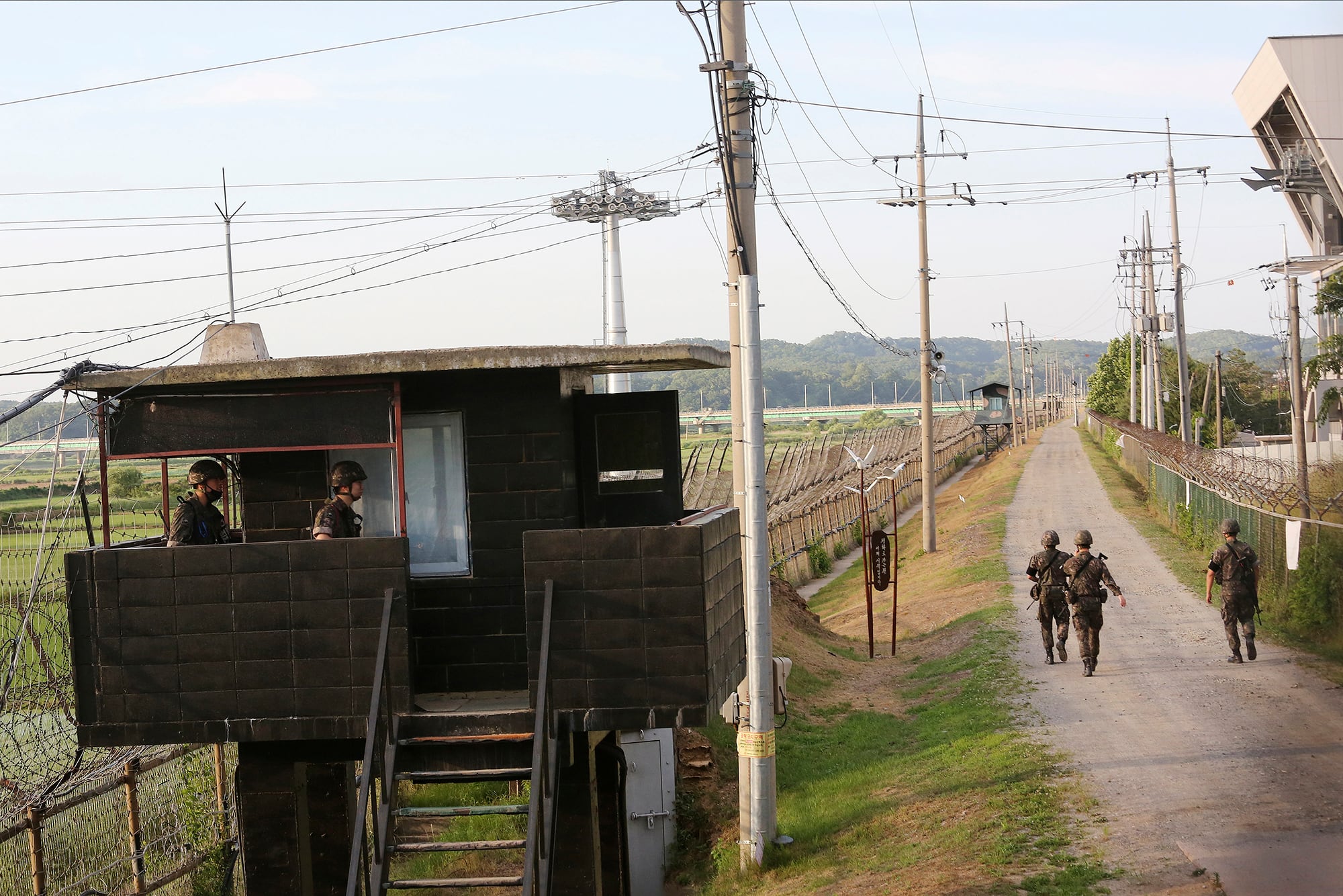 South Korean army soldiers patrol along the barbed-wire fence in Paju, South Korea, near the border with North Korea, Monday, June 15, 2020.