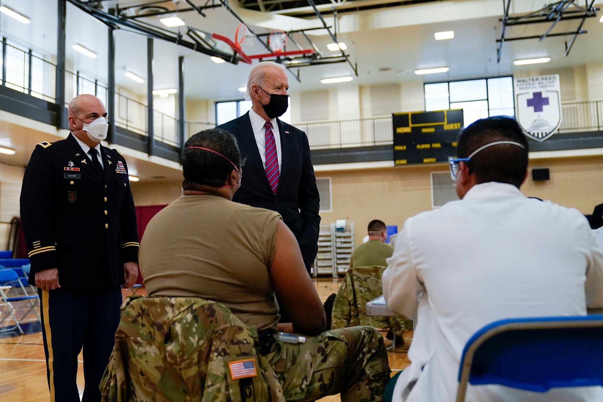 President Joe Biden tours the COVID-19 vaccine center at Walter Reed National Military Medical Center, with Col. Andrew Barr, director of Walter Reed, Friday, Jan. 29, 2021, in Bethesda, Md.