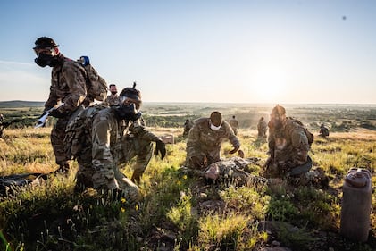 Soldiers treat a mock casualty during a physical training session at Medicine Bluffs on Fort Sill, Okla., May 29, 2020.