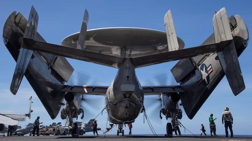 Sailors conduct pre-flight checks on an E-2C Hawkeye on Jan. 30, 30, 2021, aboard the aircraft carrier USS Theodore Roosevelt (CVN 71) in the Pacific Ocean.