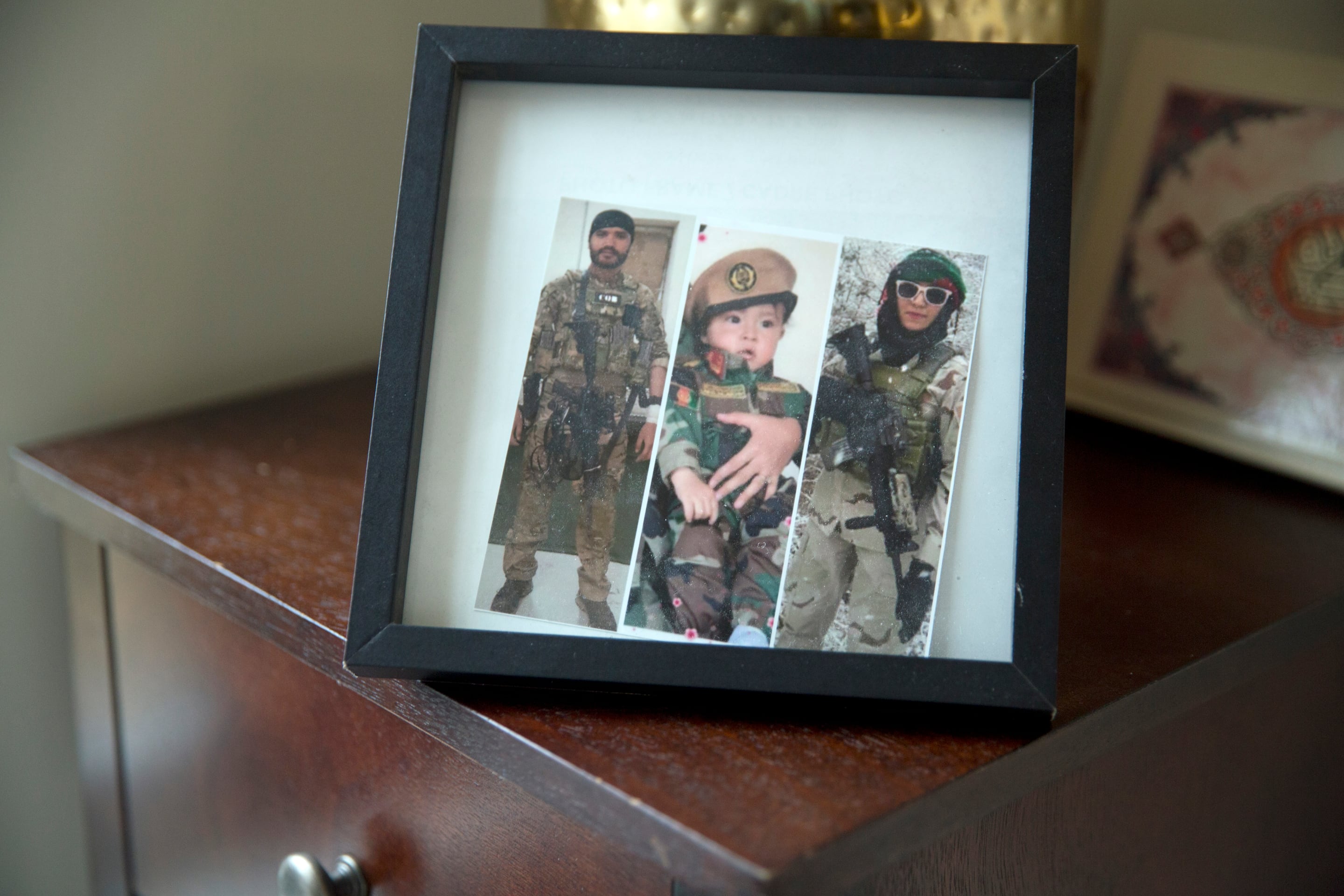 A frame in Sima Gul's living room, shows a collage of images.