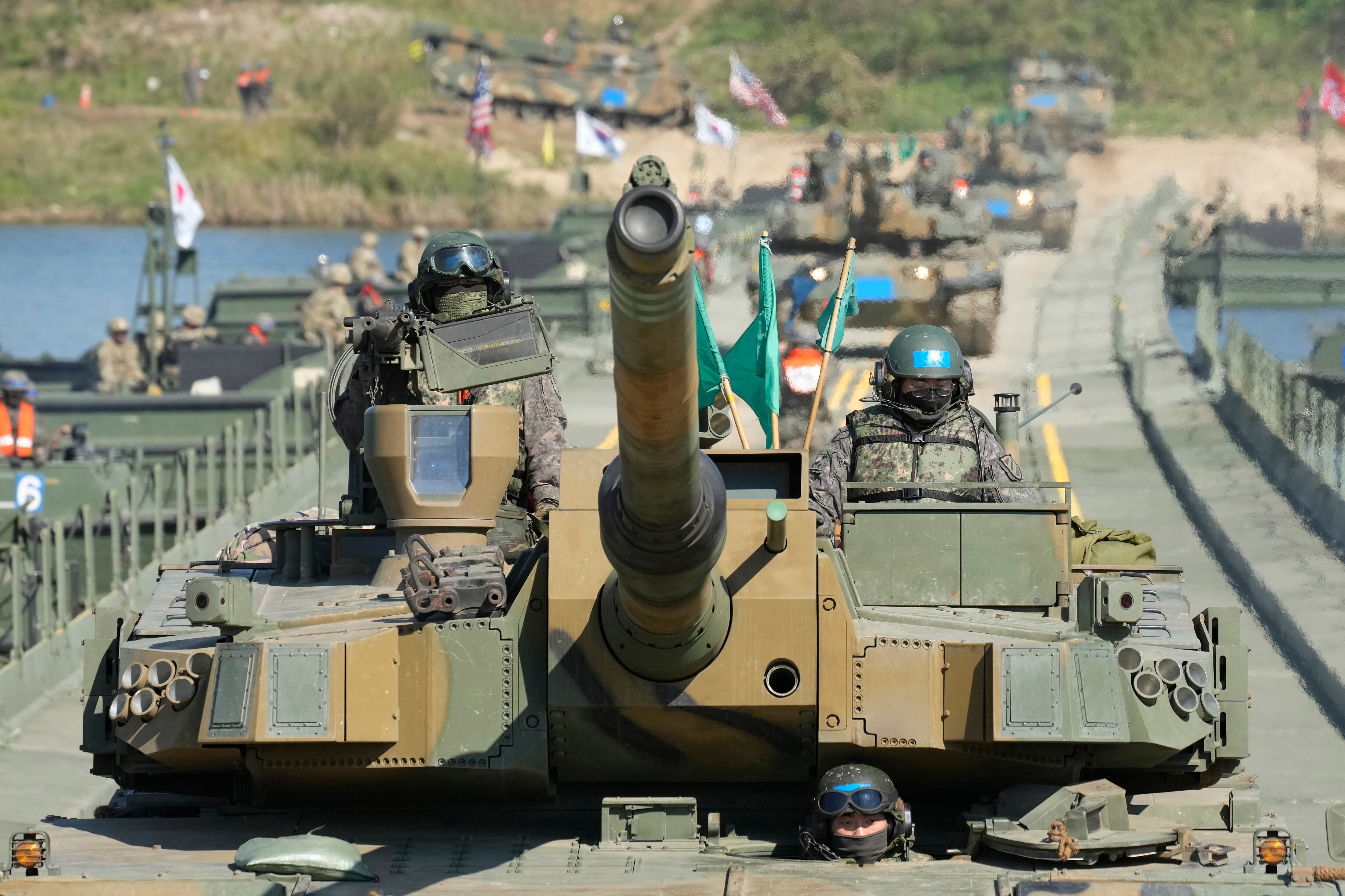 South Korean Army K2 tanks cross a floating bridge on the Namhan River during a joint river-crossing drill between South Korea and the United States in Yeoju, South Korea on Oct. 19, 2022.