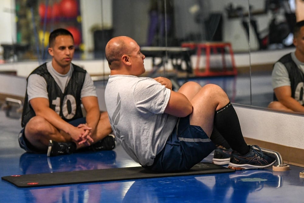 Master Sgt. Nathaniel Vallejo, 320th Missile Squadron manager of intercontinental ballistic missile training, performs as many sit-ups as he can in 60 seconds on July 3, 2021, at F.E. Warren Air Force Base, Wyoming. (Airman 1st Class Faith Iris MacIlvaine/Air Force)