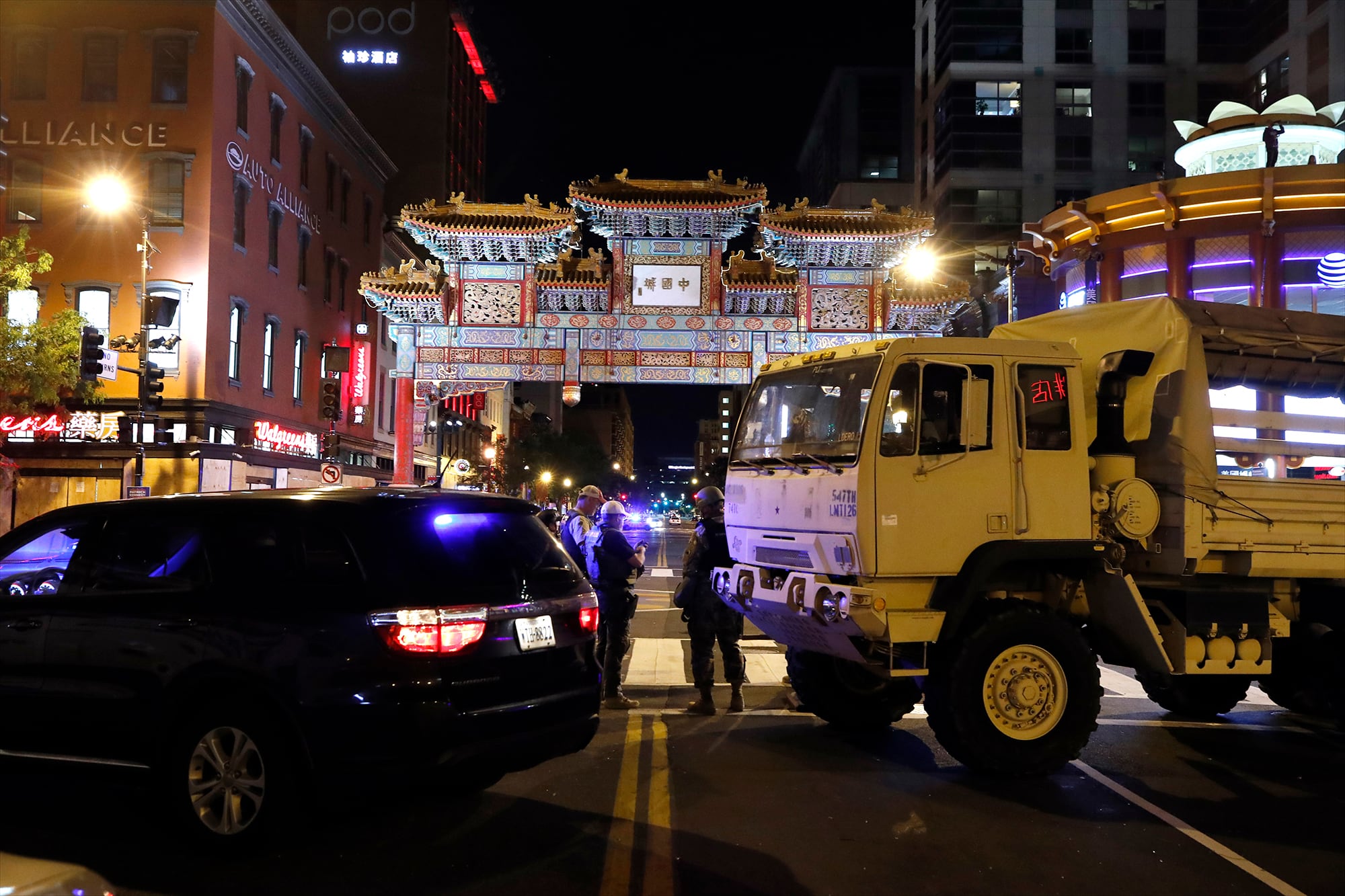 A military Humvee blocks an intersection in the Chinatown section of downtown Washington as demonstrators protest the death of George Floyd, Monday, June 1, 2020, in Washington.