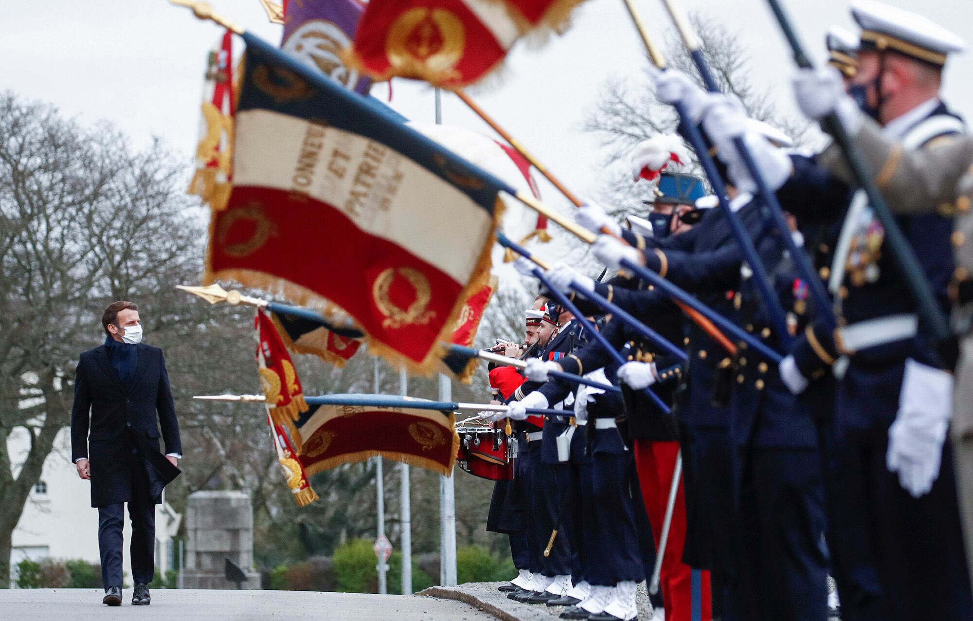 French President Emmanuel Macron review the troops prior to his New Year's speech to the French Armed Forces at Brest naval training center, western France, Tuesday, Jan. 19, 2021.