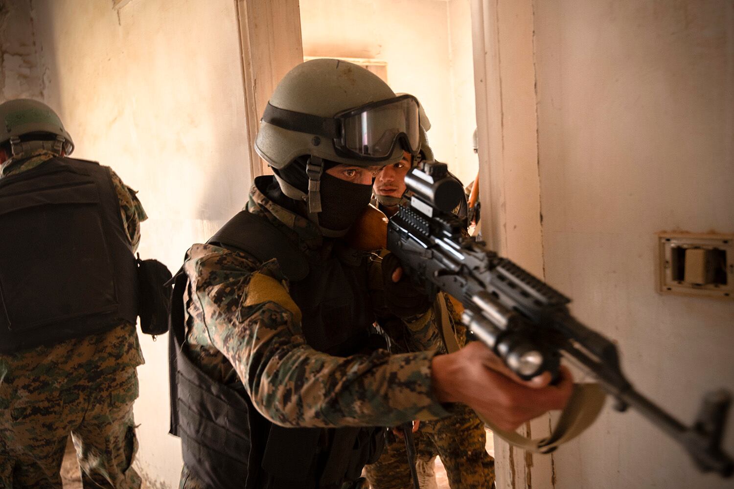 Syrian Democratic Force commando cadets clear a room during military operations in urban terrain training in Syria, Aug. 3, 2019.