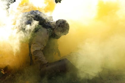 U.S. Army Sgt. 1st Class Christopher Moore secures a simulated casualty on a sked while under a simulated chemical, biological, radiological and nuclear attack during the 21st Theater Sustainment Command Best Medic Competition