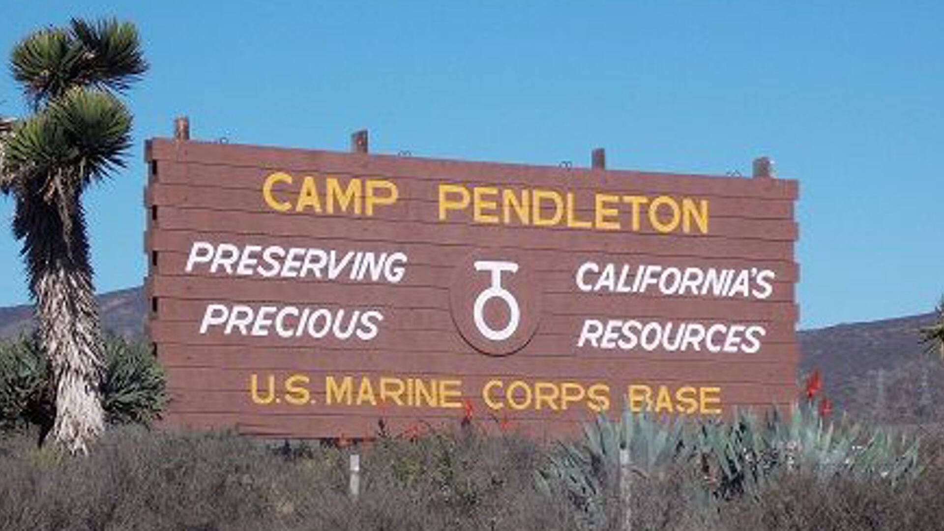 In an undated photo, the sign for Marine Corps Base Camp Pendleton, California, posted along Interstate Highway 5 reads, 'Preserving California's Precious Resources.'