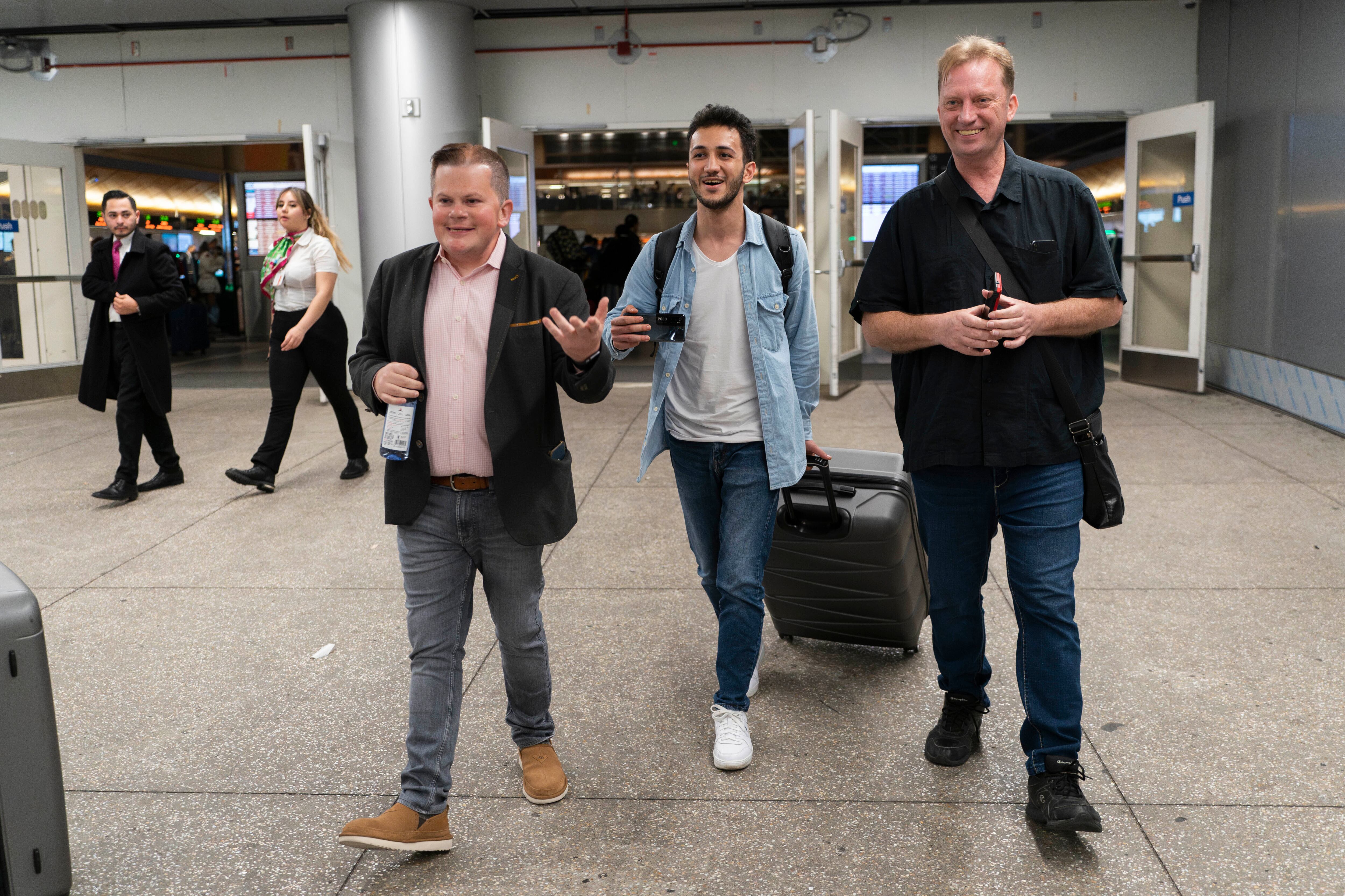 Michael White, a Navy veteran who was jailed in Iran for several years on spying charges, right, Michael's former fellow prisoner and Iranian political activist Mahdi Vatankhah, center, and Jonathan Franks, a consultant in the U.S. for families of American hostages and detainees, leave a terminal at the Los Angeles International Airport in Los Angeles, Thursday, June 1, 2023.