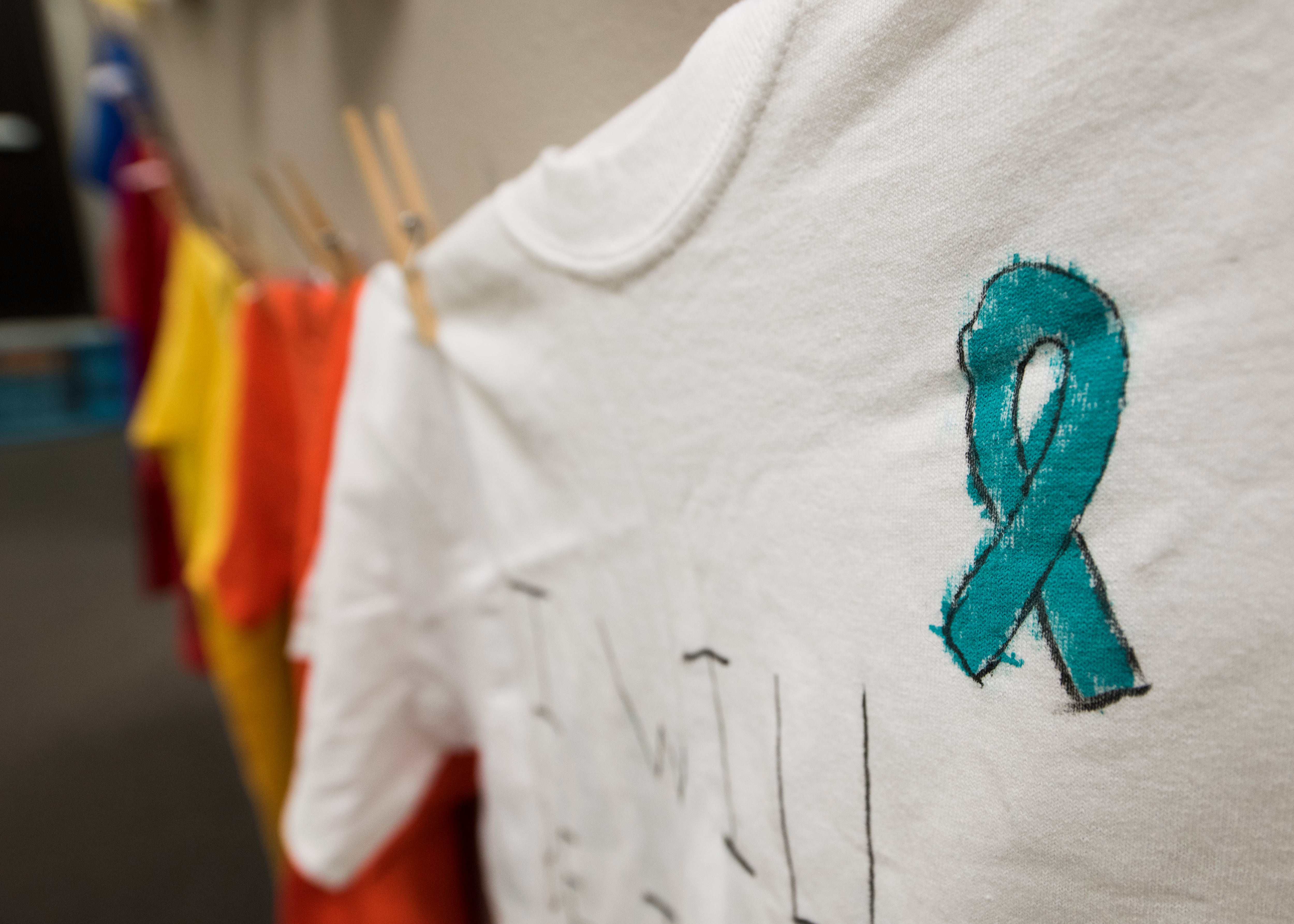 Clothes hang on a clothesline in honor of sexual assault victims in the Sexual Assault Prevention and Response office at Minot Air Force Base, North Dakota, April 10, 2018.