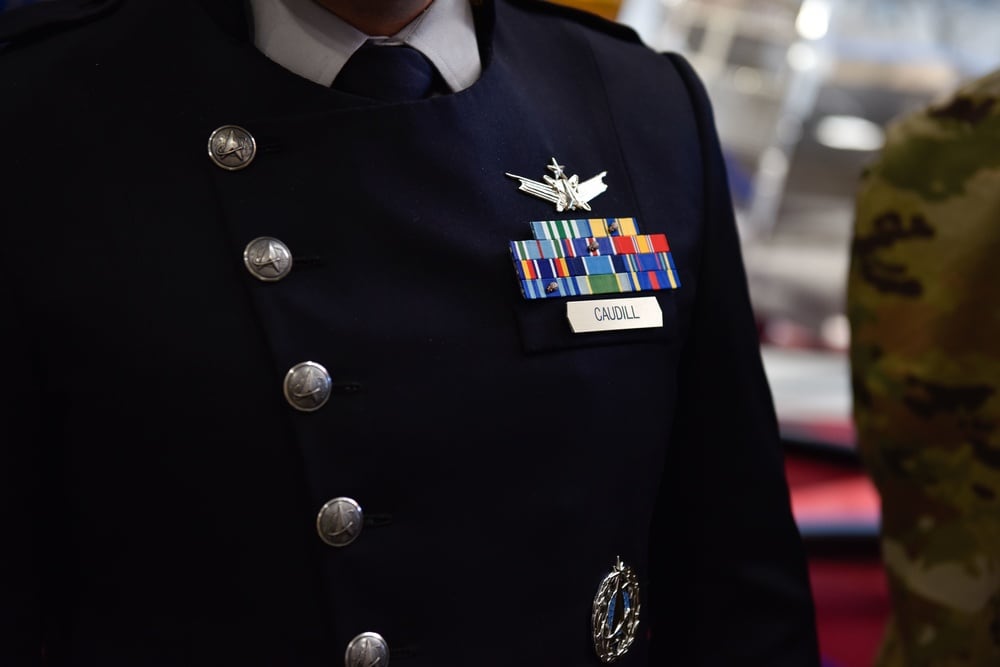 U.S. Space Force Maj. Dylan Caudill, a member of the Office of the Chief of Space Operations, presents the new service dress uniform to guardians at Buckley Space Force Base, Colo., Oct 20, 2021. The service dress prototype features a midnight blue, double-breasted overcoat with a matching tie, grey undershirt and charcoal pants, taking inspiration from 19th-century military uniforms. (Airman 1st Class Wyatt Stabler/Space Force)