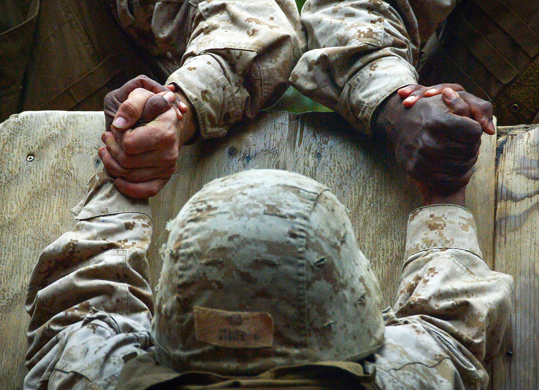 Recruits from Company C help a fellow recruit climb an 8-foot wall at Parris Island, S.C., Dec. 14, 2012