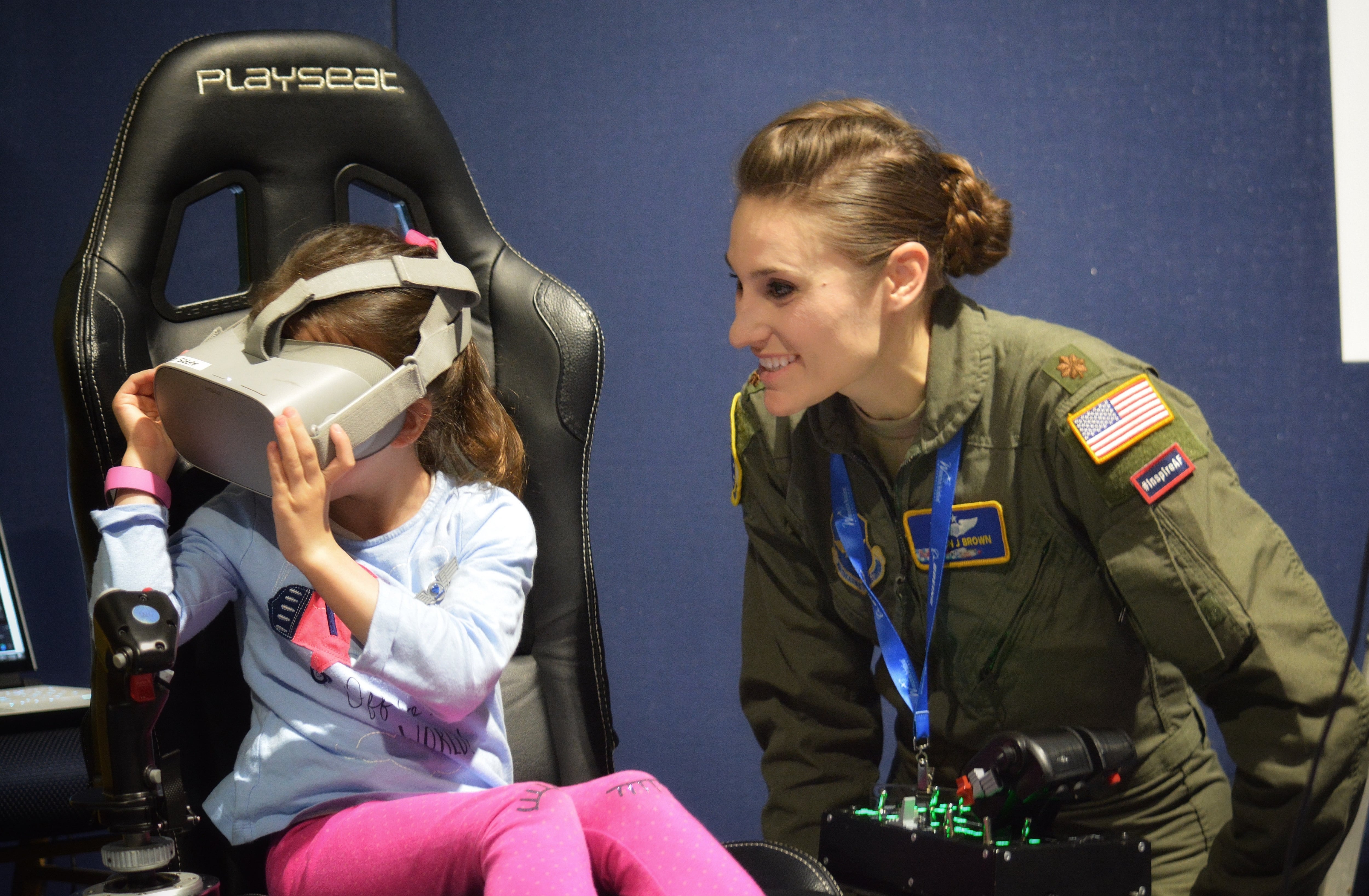 Maj. Afton Brown, Air Force Recruiting Service Detachment 1, assists a young aviator during the Girls in Aviation Day at the Women in Aviation International conference in Lake Buena Vista, Fla., March 7, 2020. (Christa D’Andrea/Air Force)