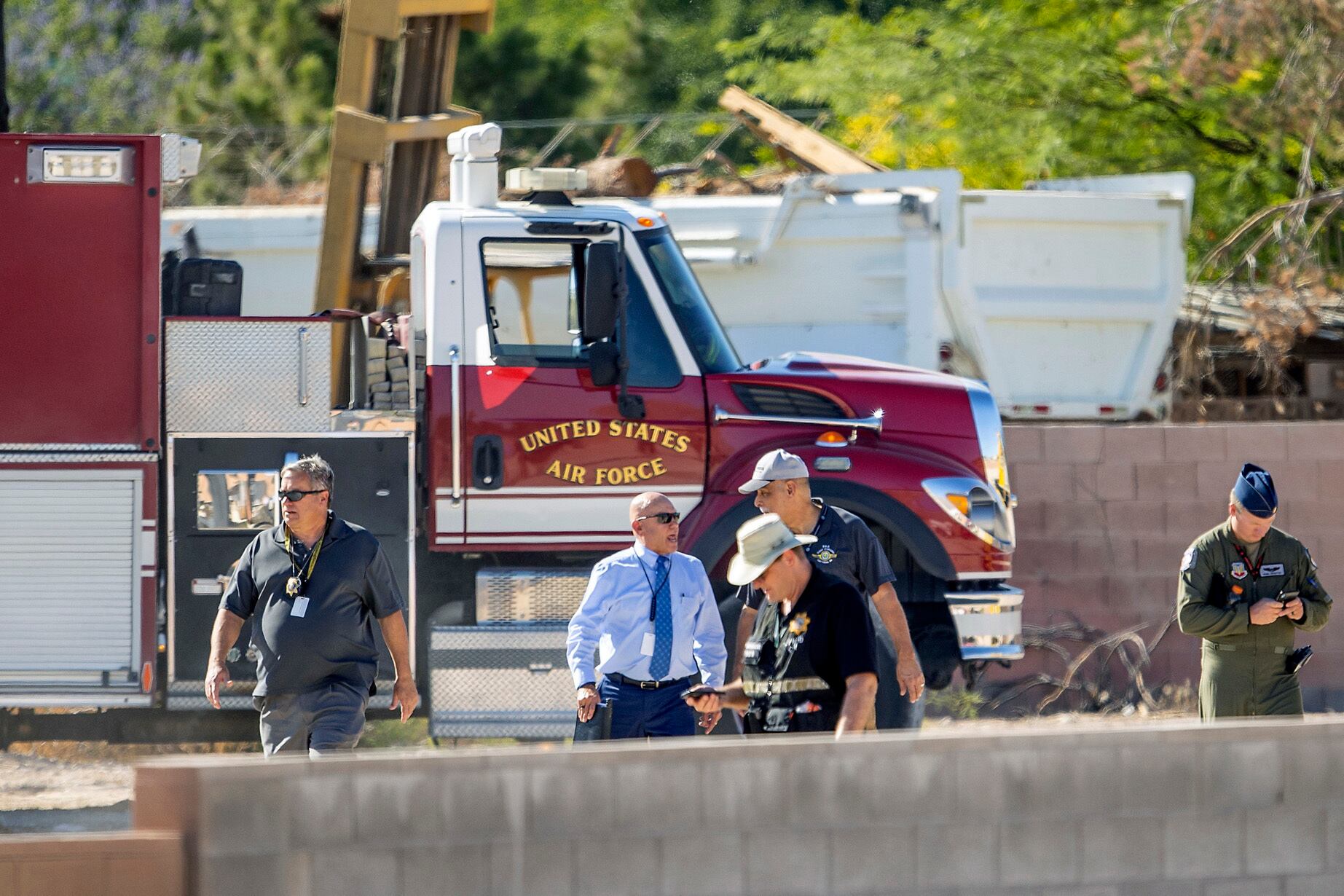 In this May 24, 2021 file photo military personnel, officers and officials investigate an airplane crash near Nellis Air Force Base, in Las Vegas. Federal investigators reported Friday, June 11, 2021, that a pilot who was killed when a Dassault Mirage F-1 crashed last month while approaching Nellis Air Force Base reported an emergency and ejected moments before the jet slammed to the ground and burst into flames in a residential area. (L.E. Baskow/Las Vegas Review-Journal via AP)