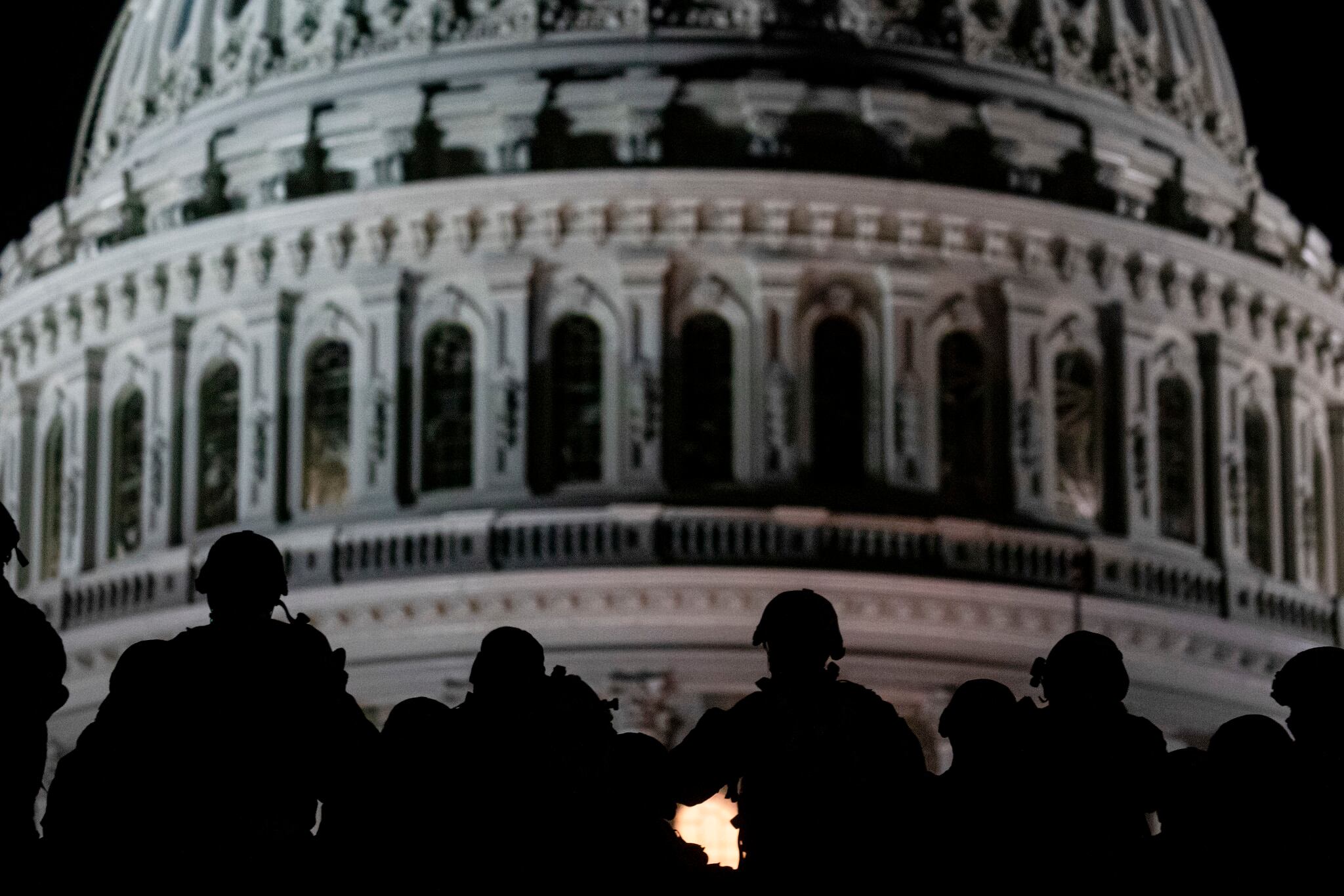 U.S. soldiers with the Virginia National Guard listen to a squad leader briefing after arriving near the Capitol in Washington on, Jan. 13, 2021.