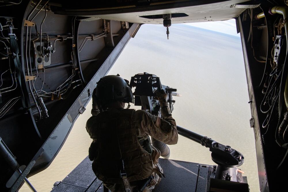 A U.S. Air Force flight engineer assigned to the 7th Special Operations Squadron readies to fire the rear-mounted .50 caliber machine gun on a CV-22B Osprey at a local range, Oct. 20, 2021. (Staff Sgt. Brandon Nelson/Air Force)