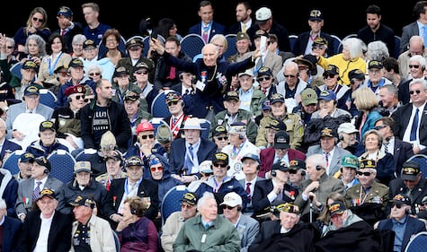 U.S. World War II veteran Jacques Michienzi, center, stands up among other veterans during a ceremony to mark the 75th anniversary of D-Day at the Normandy American Cemetery