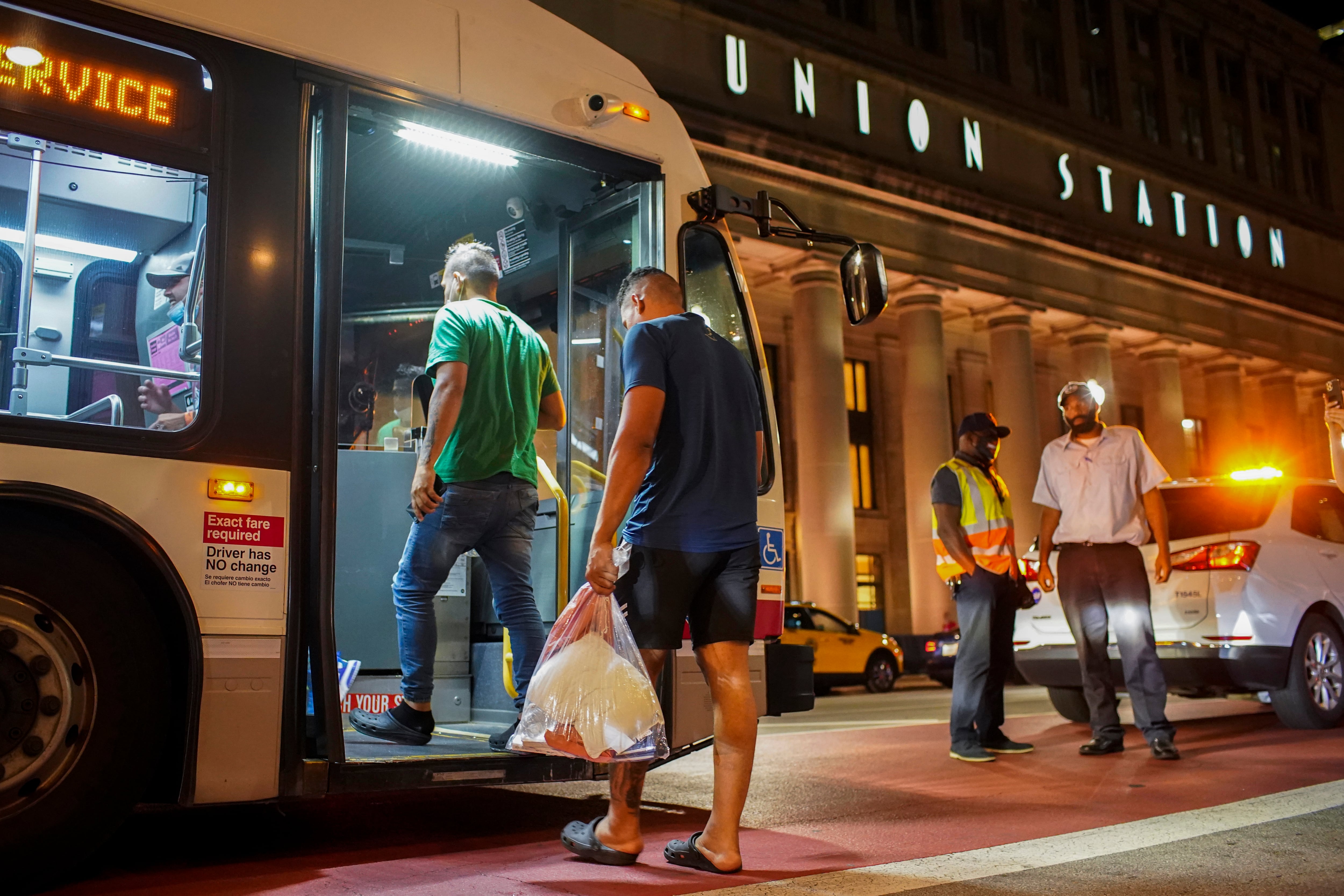 A group of people board a Chicago Transit Authority bus before being taken to a Salvation Army after arriving on a bus with other migrants from Texas at Union Station, Wednesday, Aug. 31, 2022, in Chicago.