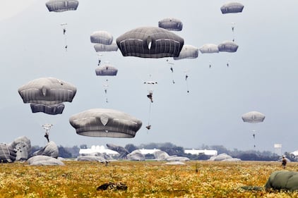 U.S. Army paratroopers descend onto Juliet Drop Zone after exiting a U.S. Air Force C-130 Hercules aircraft during airborne operations at Pordenone, Italy, Oct. 1, 2020.