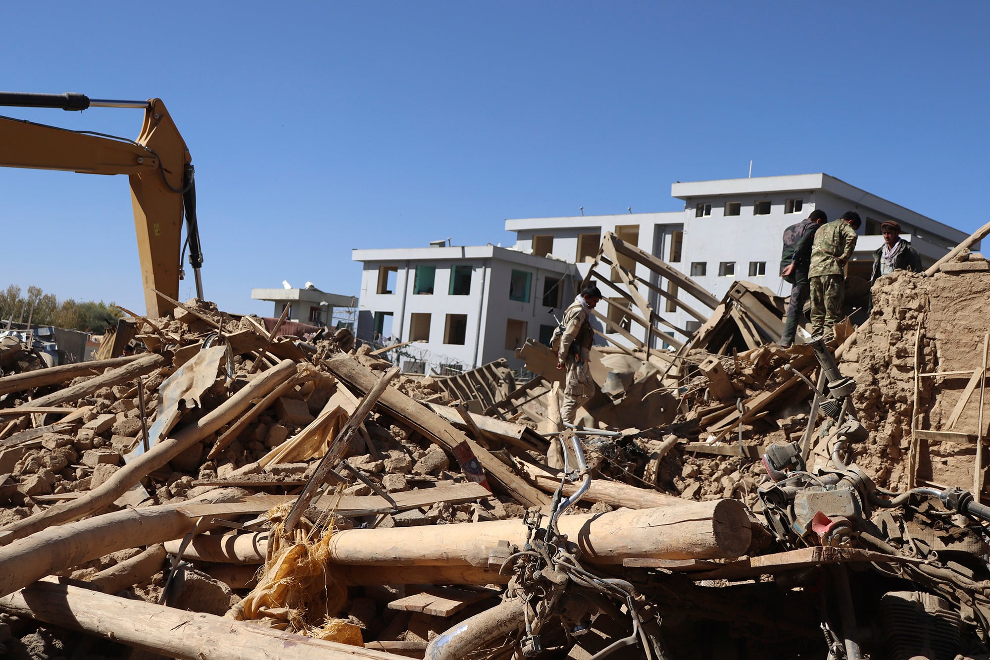 Afghan security inspects the site of a suicide car bombing in Ghor province western of Kabul, Afghanistan, Sunday, Oct. 18. 2020.