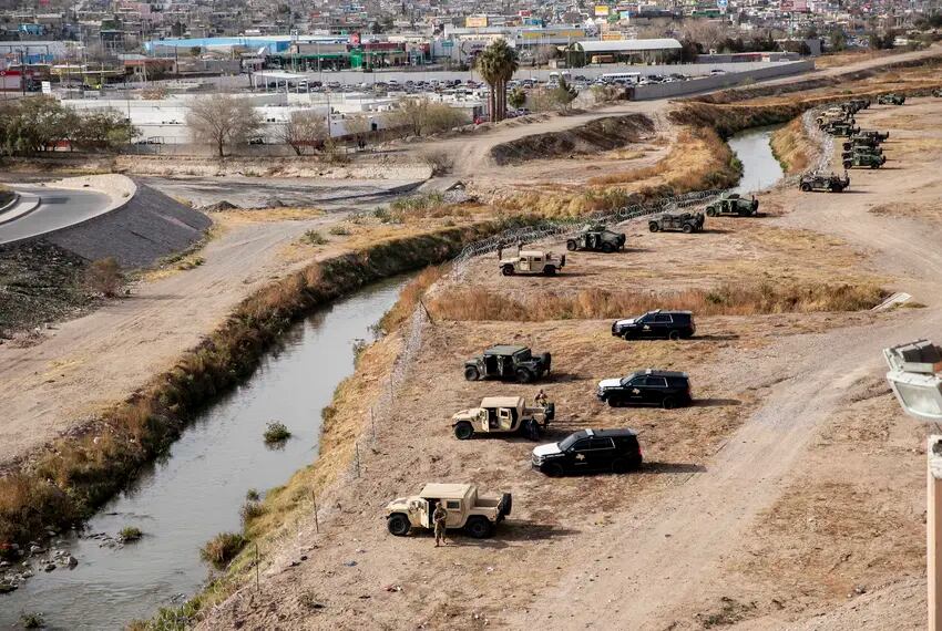 Texas National Guard members and DPS officers take positions along the Rio Grande in El Paso to help patrol the border between the U.S. and Mexico December 2022.