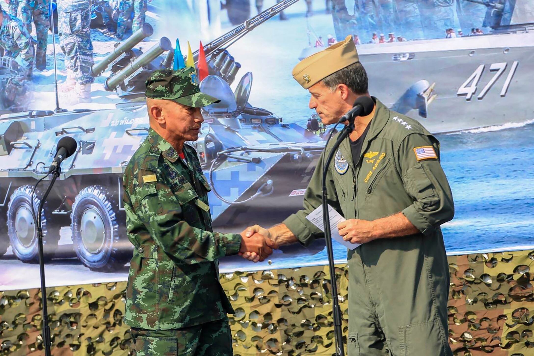 In this photo released by Royal Thai Army, Thailand Chief of Defence Forces General Chalermpol Srisawasdi, left, shakes hands with Commander of the United States Indo-Pacific Command Adm. John Aquilino, during opening ceremony of Cobra Gold 2023 in Rayong Province Thailand, Tuesday, Feb. 28, 2023.