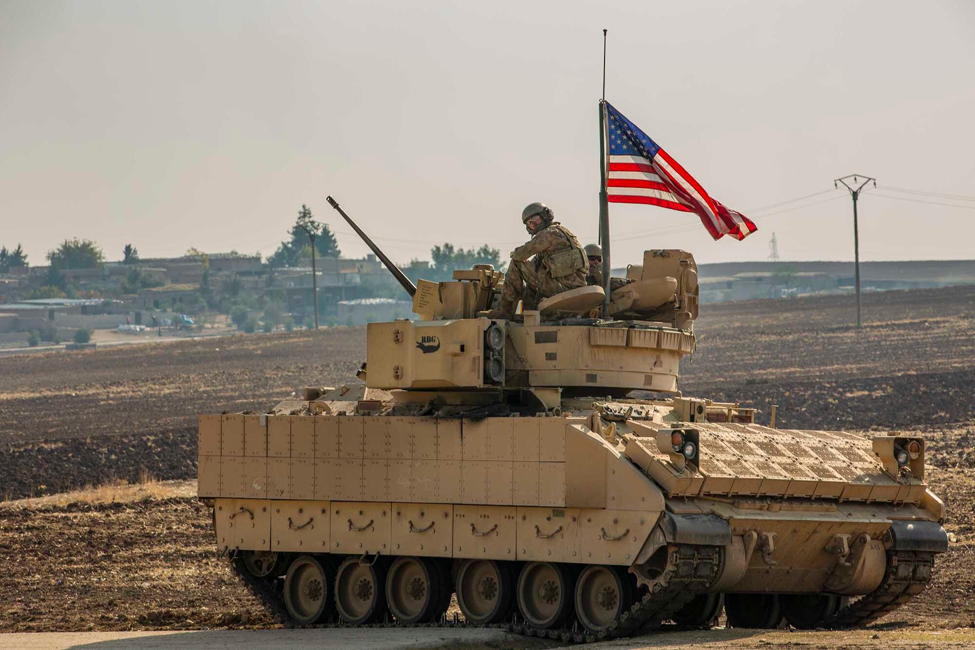 A U.S. soldier sits in the gunner’s seat of a M2 Bradley Infantry Fighting Vehicle in Syria in the Central Command  area of responsibility, Dec. 11, 2020.