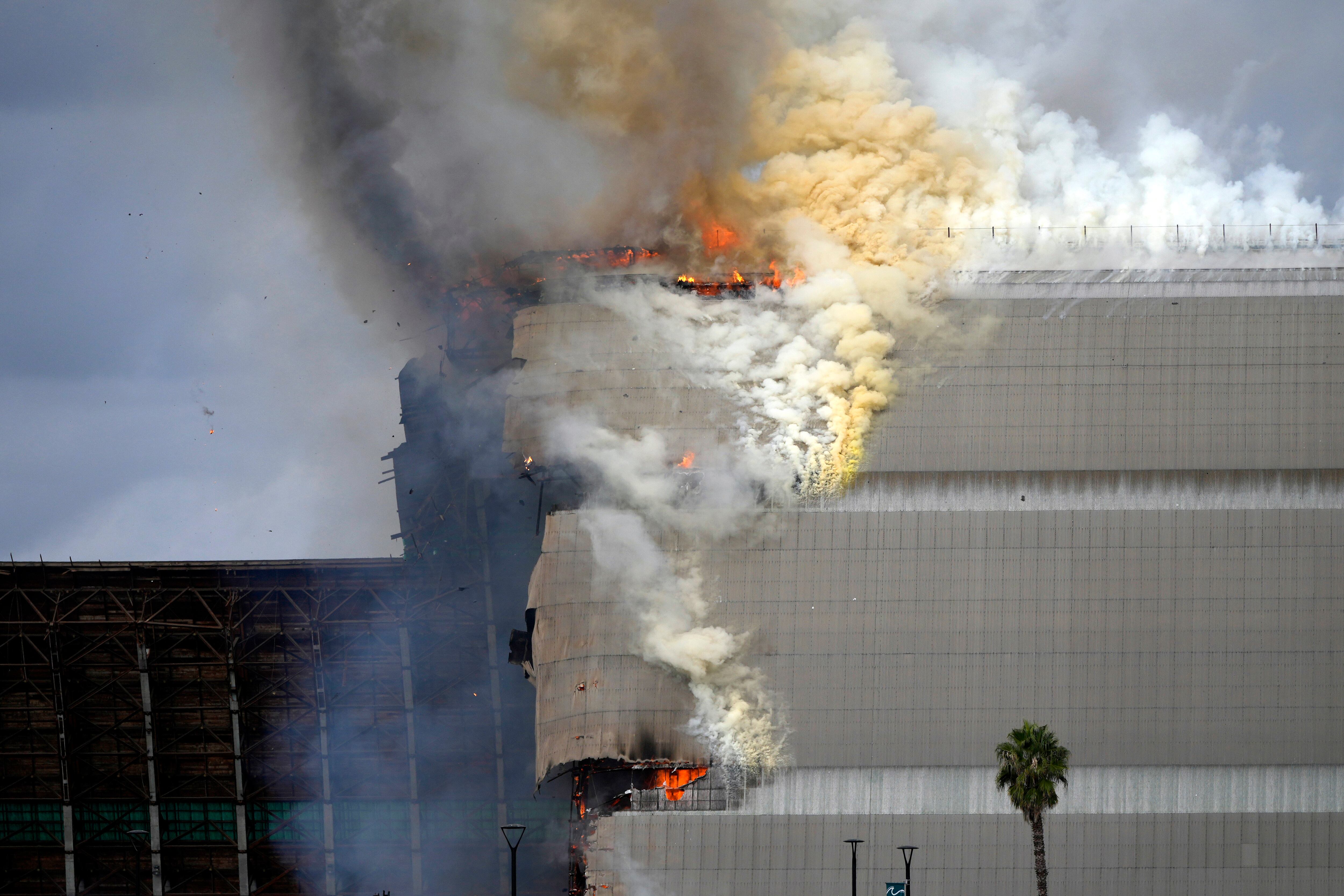 A historic blimp hangar burns in Tustin, Calif., Tuesday, Nov. 7, 2023.