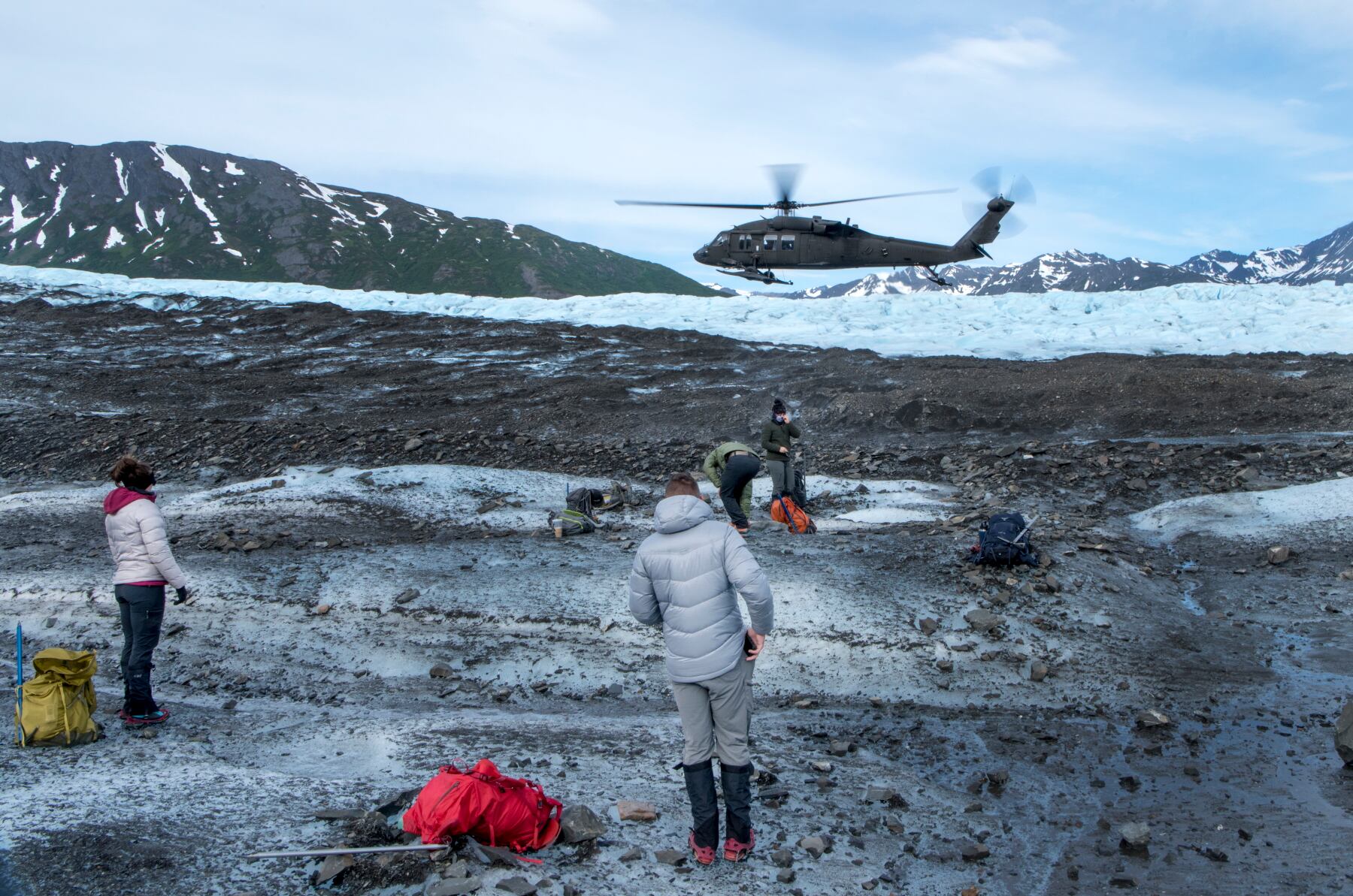 In this June 18, 2020, photo, an Alaska Army National Guard UH-60 Black Hawk helicopter departs Colony Glacier after dropping off personnel recovery team members assigned to Joint Base Elmendorf-Richardson, Alaska.