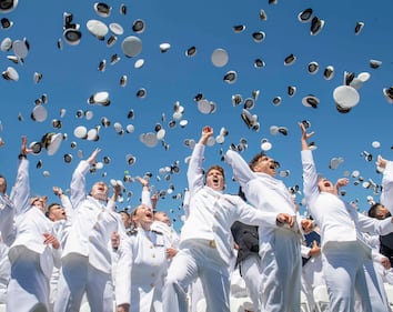 Midshipmen toss their covers in the air during the United States Naval Academy's Class of 2019 Graduation Day and Commissioning Ceremony