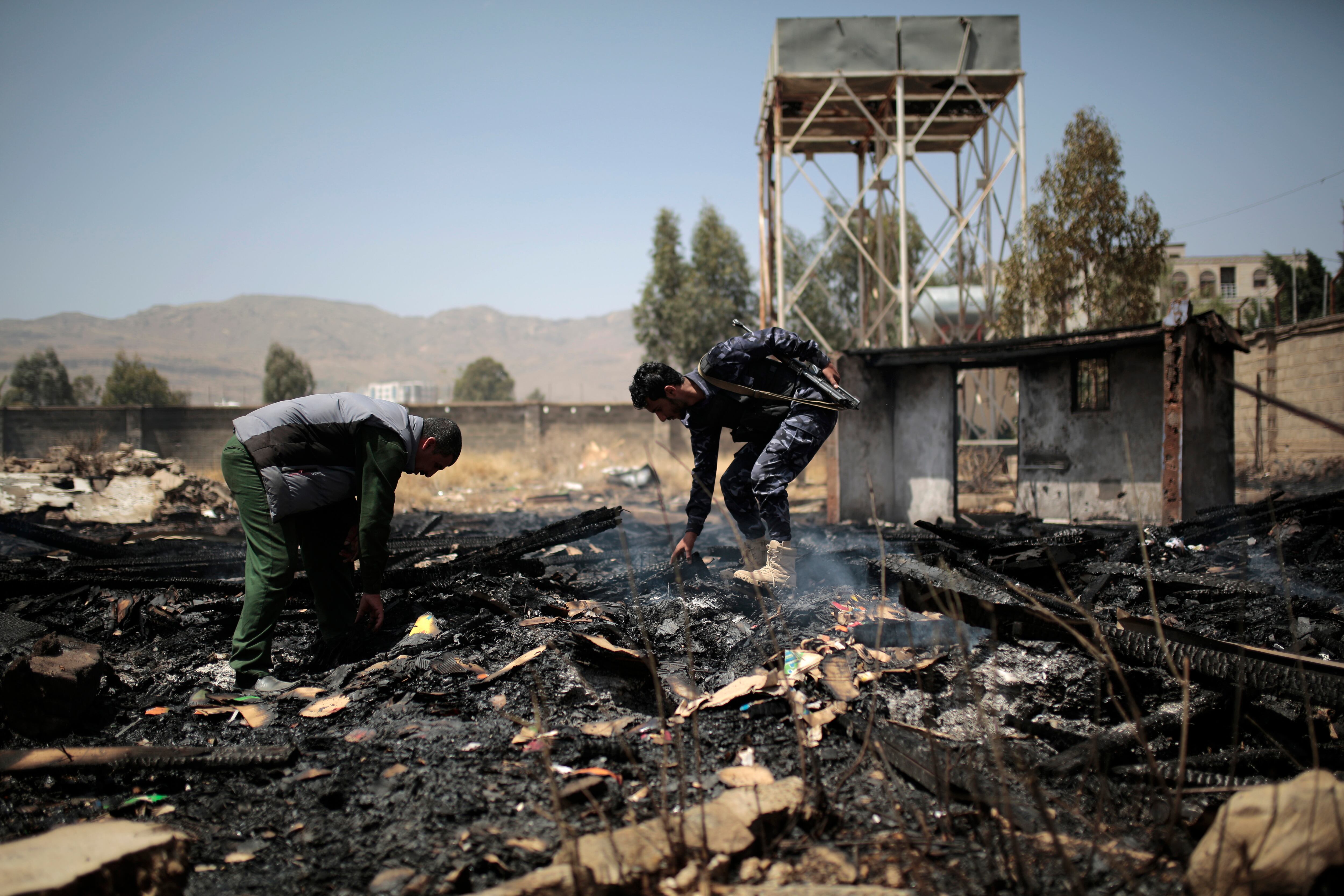 Yemeni police inspect a site of Saudi-led airstrikes targeting two houses in Sanaa, Yemen, Saturday, March 26, 2022. A Houthi media office claimed an airstrike hit houses for guards of the social insurance office, killing at least seven people and wounding three others, including women and children. (Hani Mohammed/AP)