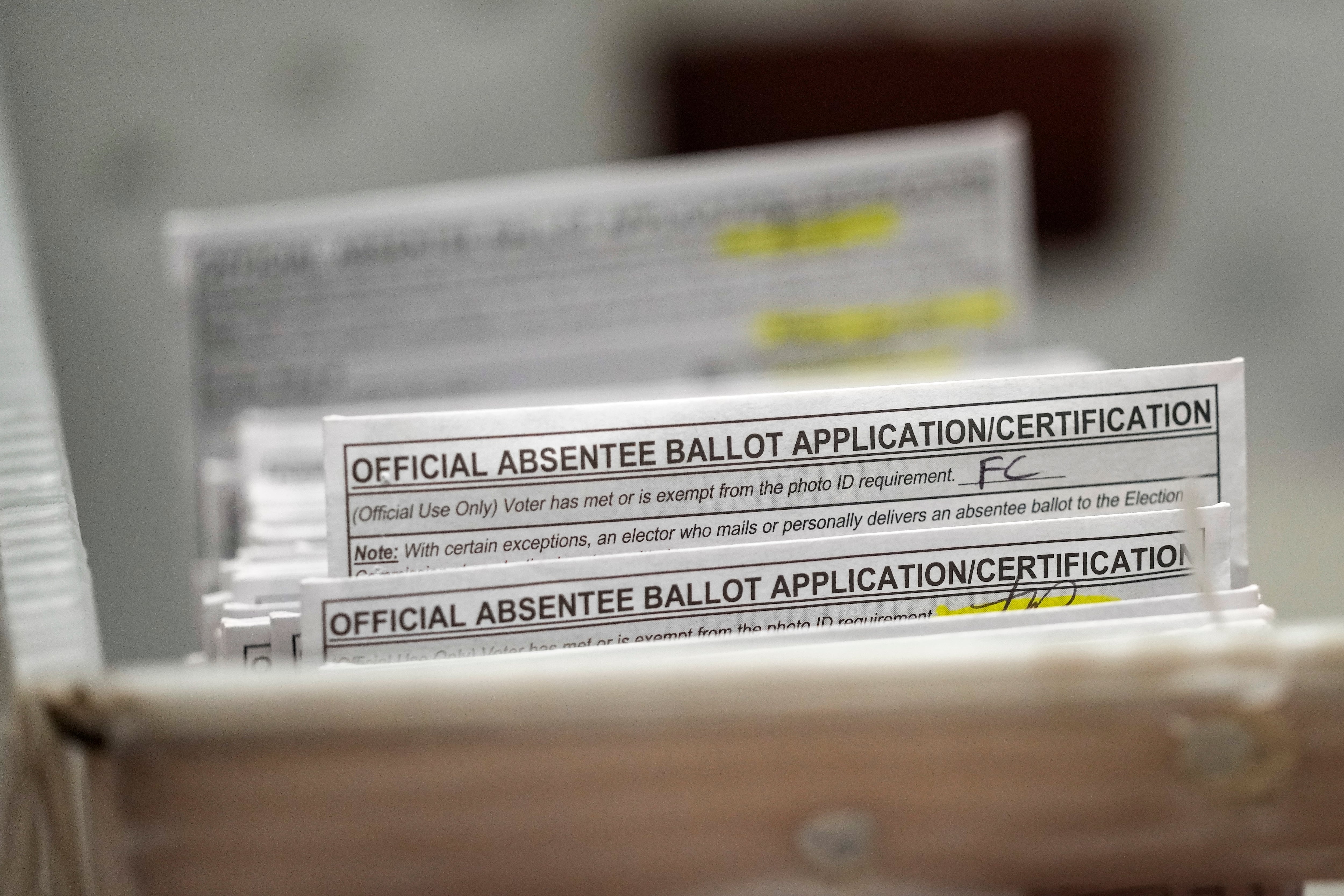 Absentee ballots are seen during a count at the Wisconsin Center for the midterm election on Nov. 8, 2022, in Milwaukee.