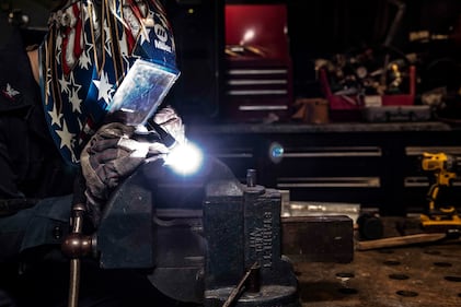 Hull Maintenance Technician 3rd Class Drew Knutson welds stainless steel and aluminum angles in the repair shop of the aircraft carrier USS Ronald Reagan (CVN 76) on July 8, 2020, in the South China Sea.