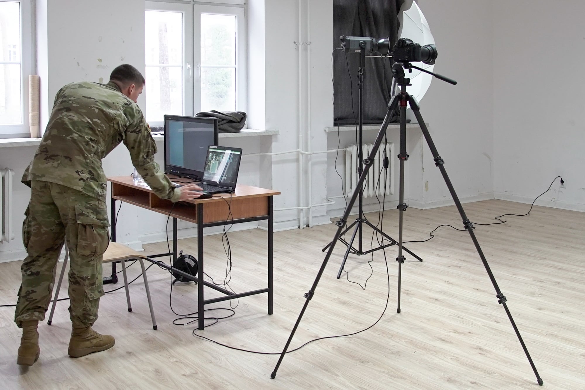 U.S. Army Spc. Rolyn Kropf prepares camera equipment for Department of the Army photos of U.S. soldiers assigned at Zagan, Poland, Oct. 30, 2018.