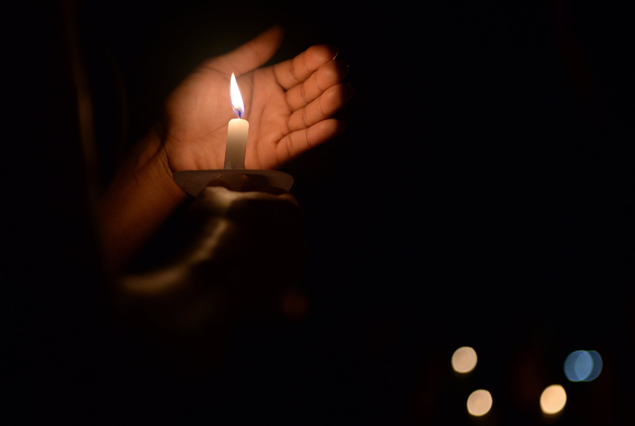 A candle burns during Lights for Lives on Biloxi Beach