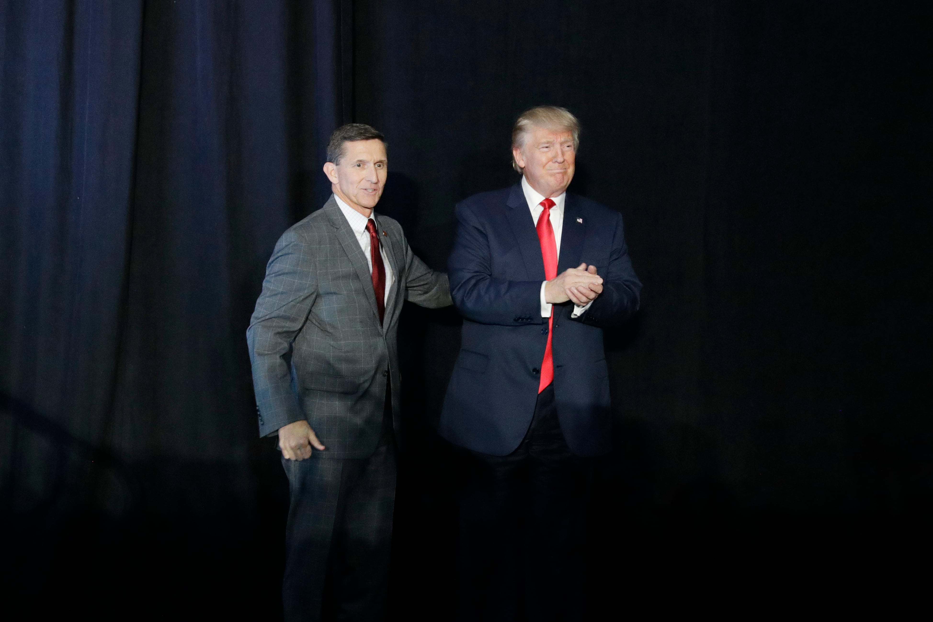 Retired Lt. Gen. Michael Flynn, left, introduces Republican presidential candidate Donald Trump at a campaign rally on Sept. 29, 2016, in Bedford, N.H.